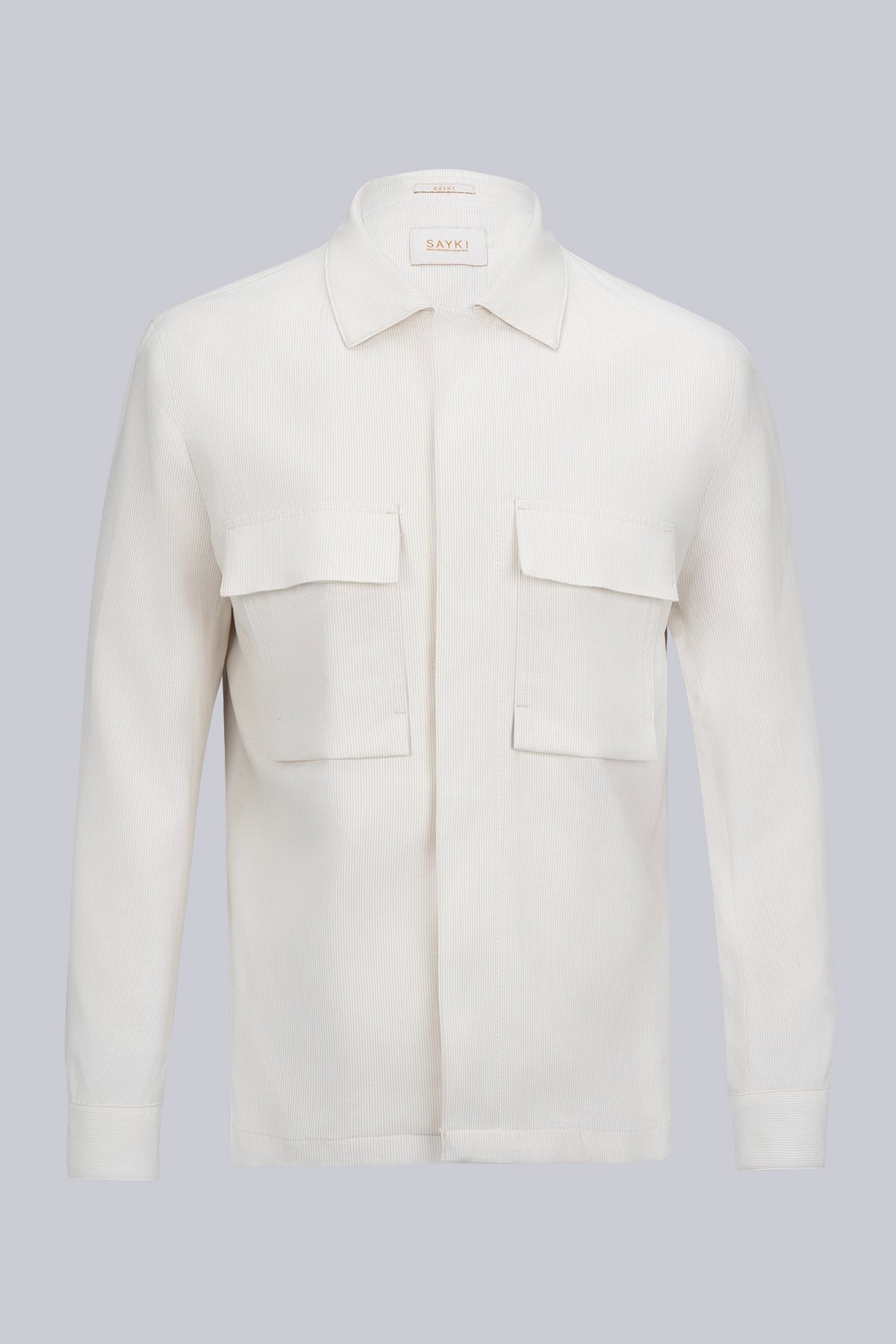 A crisp white, long-sleeved button-up shirt with a classic collar and two front patch pockets.