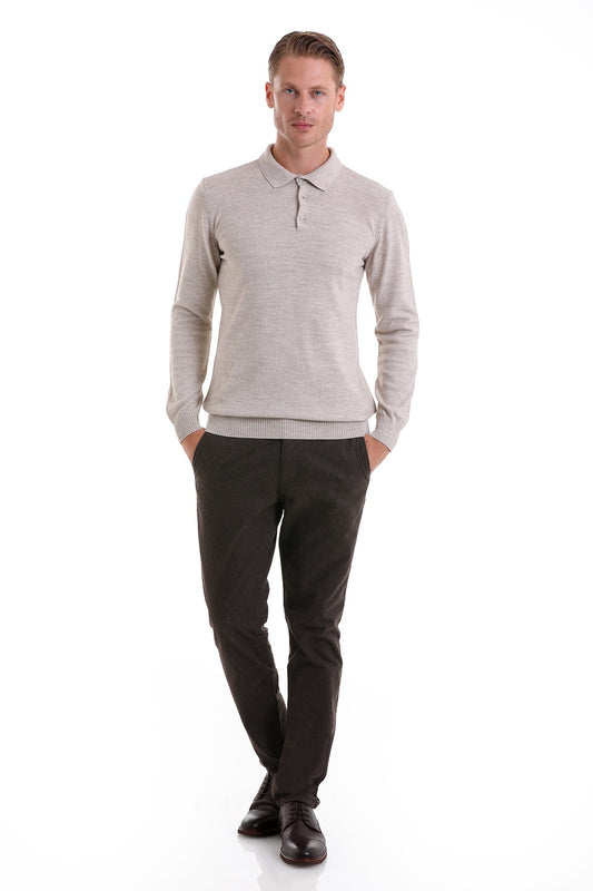 A man wearing a light gray, long-sleeved knit polo shirt with ribbed cuffs and hem.