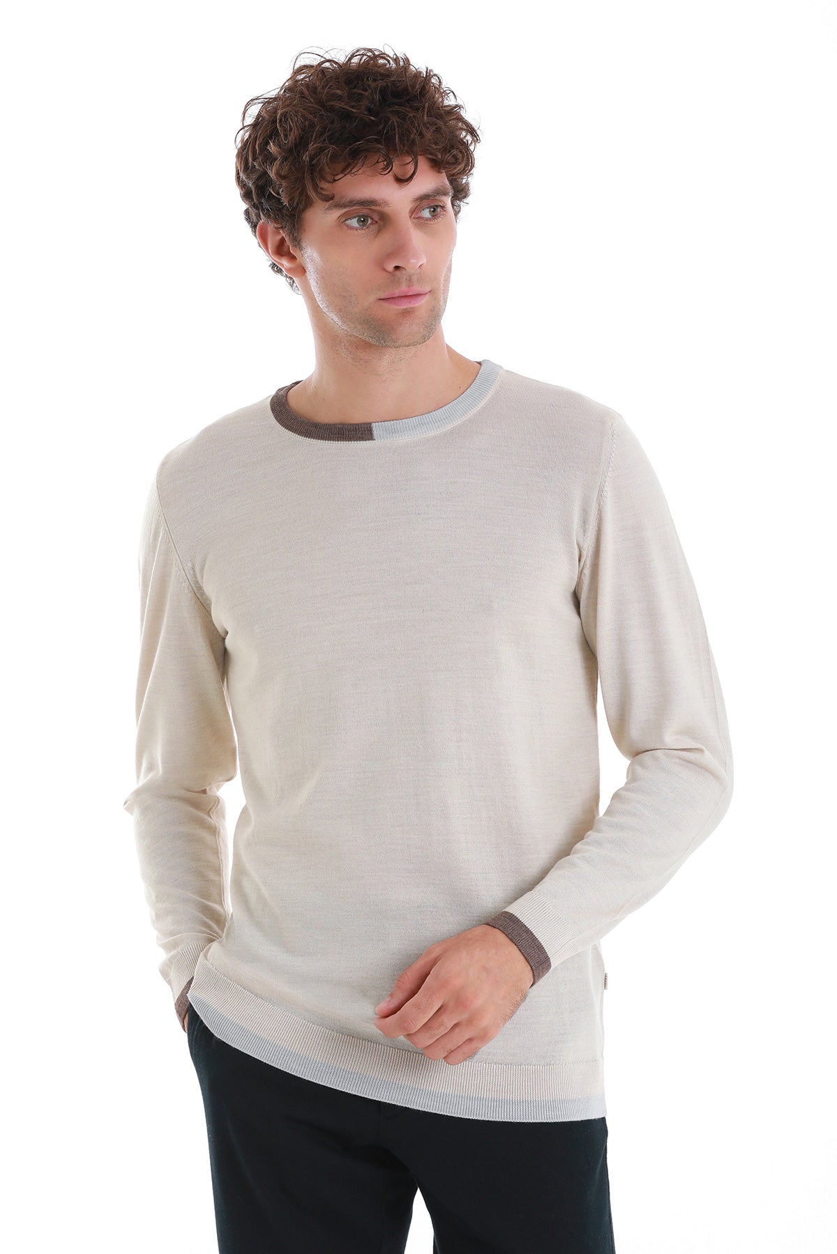 Cream-colored long-sleeved sweater with contrasting dark gray ribbed trim at the neckline and cuffs.
