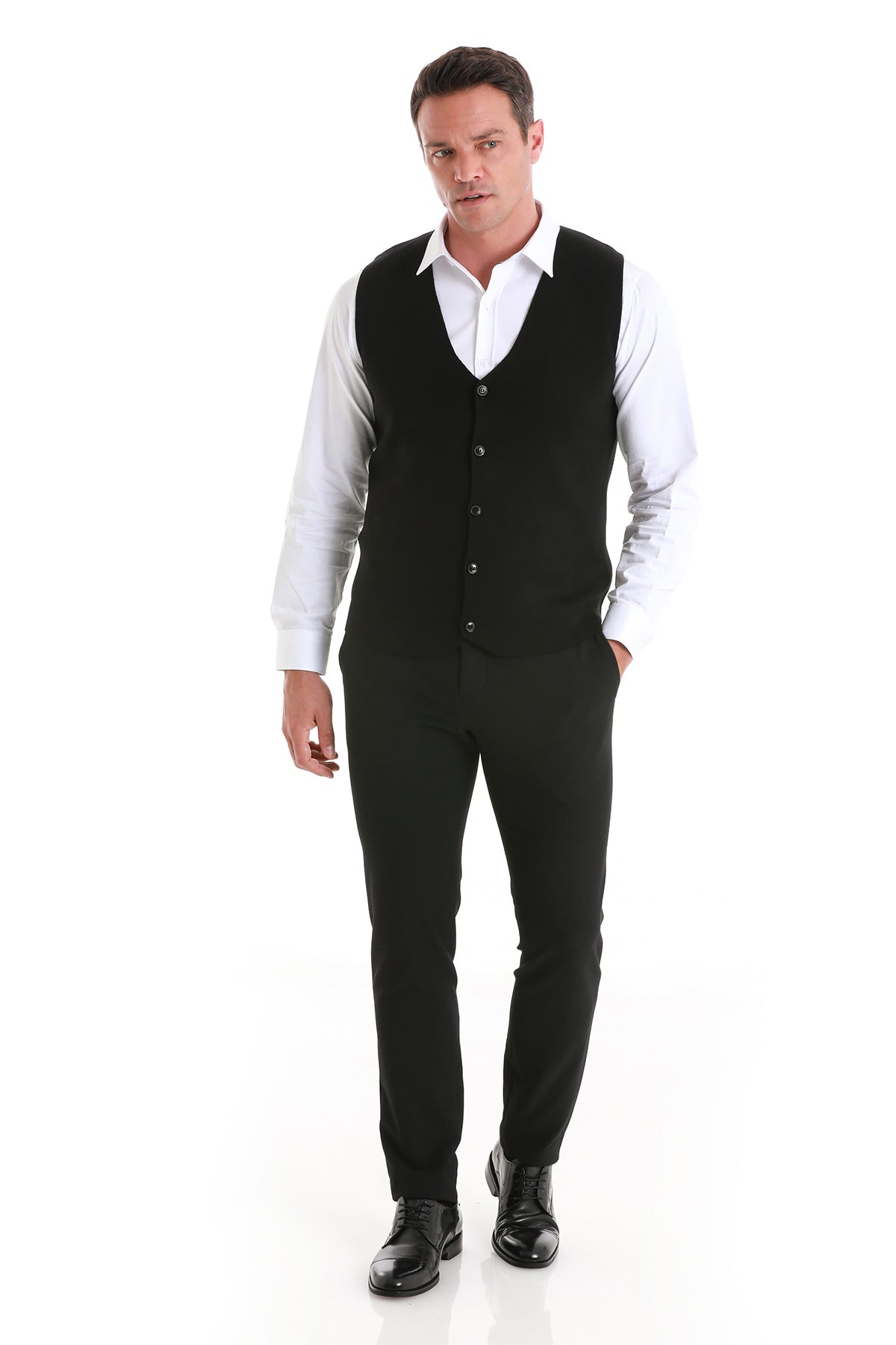 Black knit vest with button closure worn over a white dress shirt.