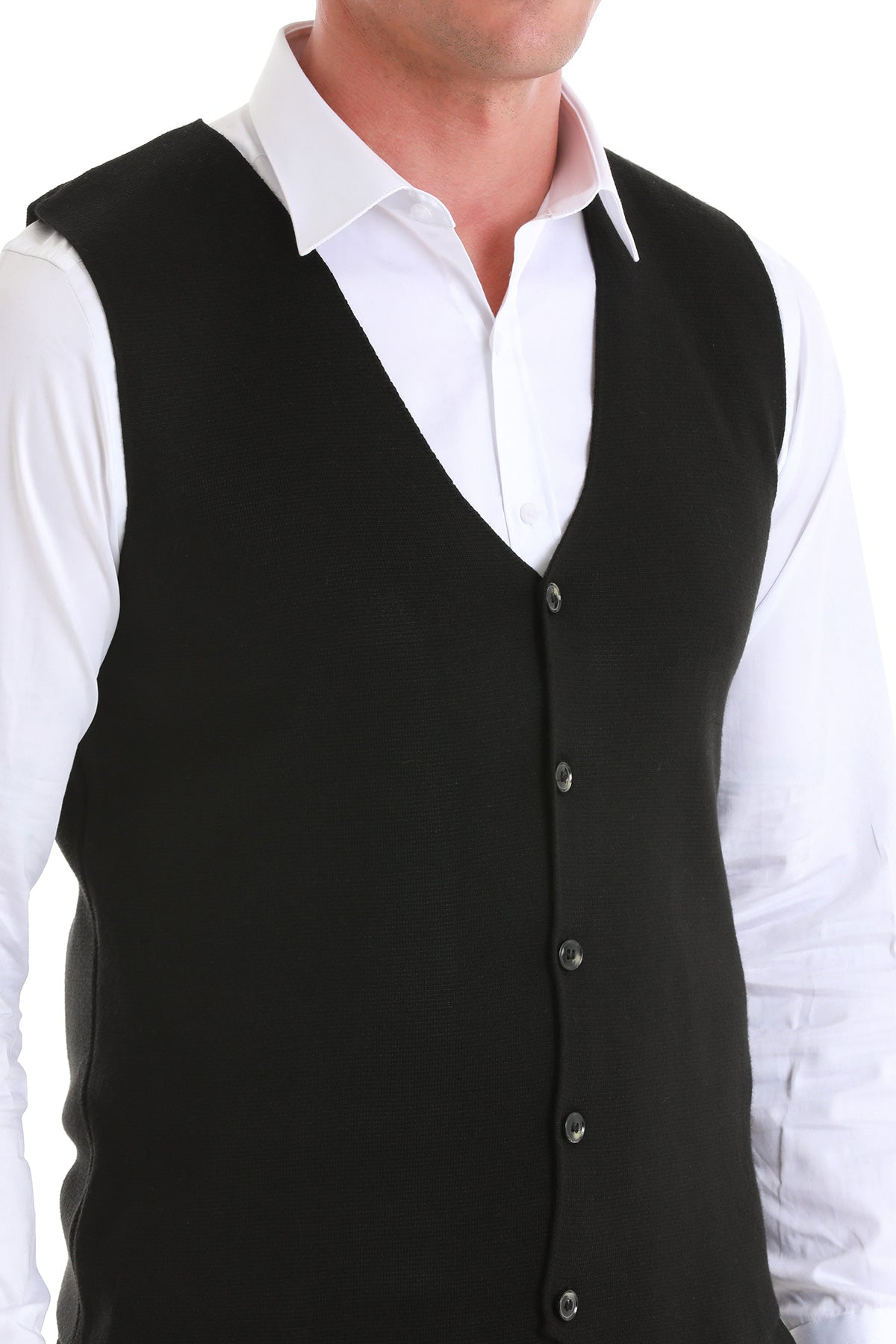 Black button-front vest worn over a white dress shirt.