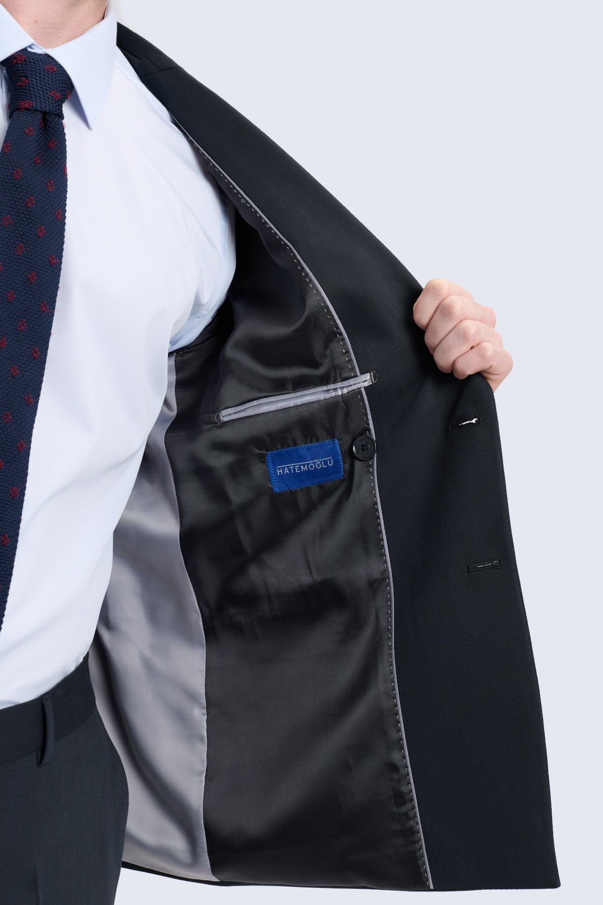 Regular fit black peak lapel double-breasted suit jacket with satin-lined interior and blue brand label