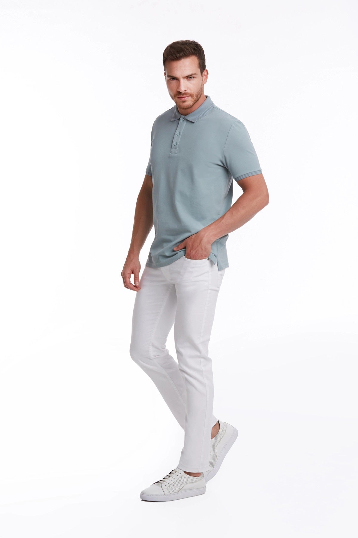 A man wearing a light blue short-sleeved polo shirt with a classic collar and buttoned placket.