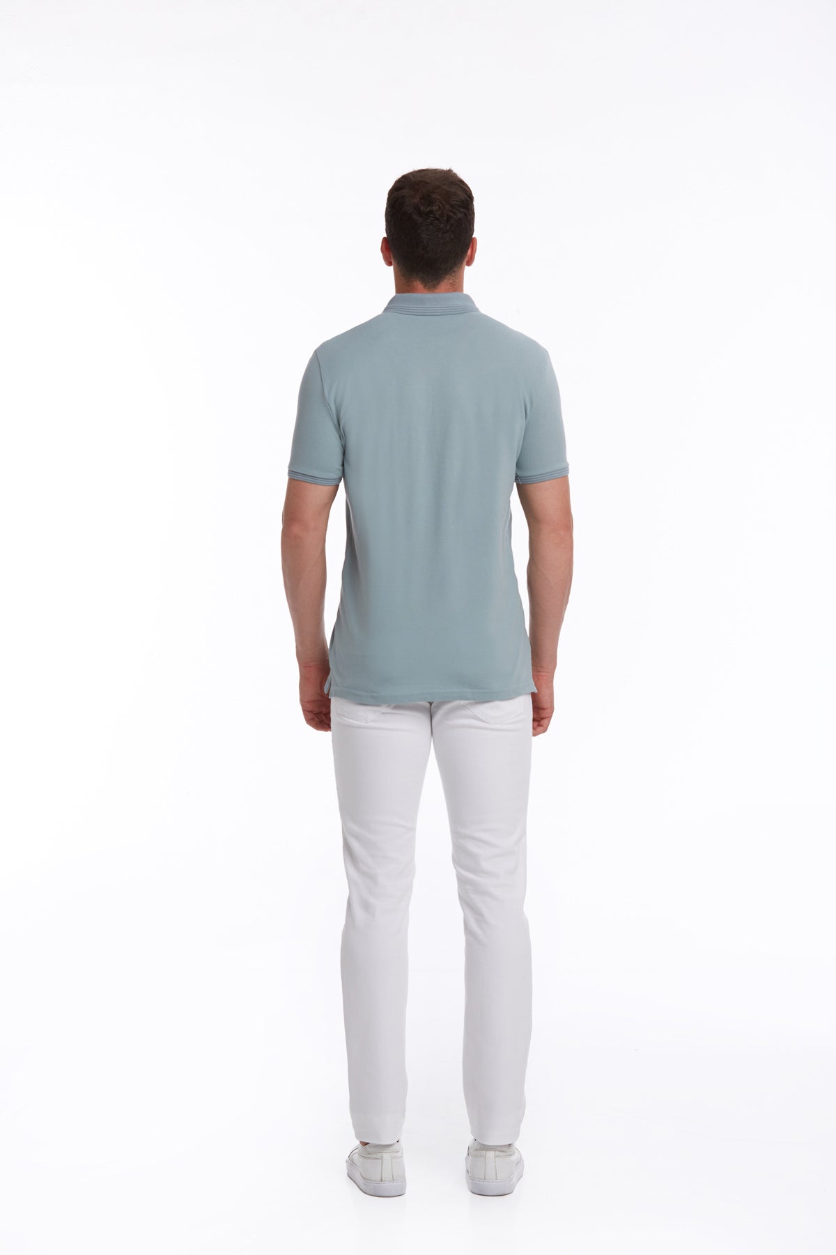 A man wearing a light blue short-sleeved polo shirt with a classic collar and neatly stitched seams.