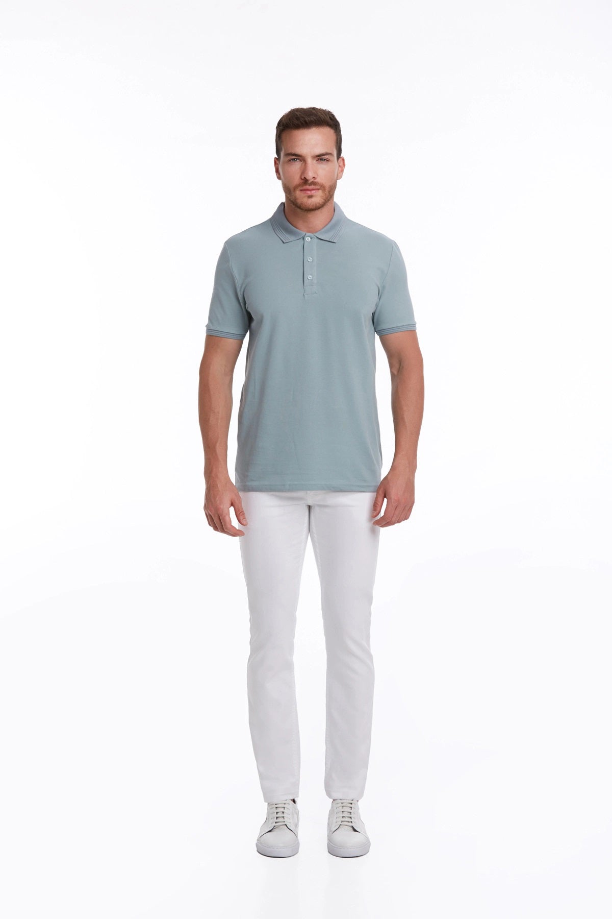 A man wearing a light blue, short-sleeved polo shirt with a classic collar and buttoned placket.