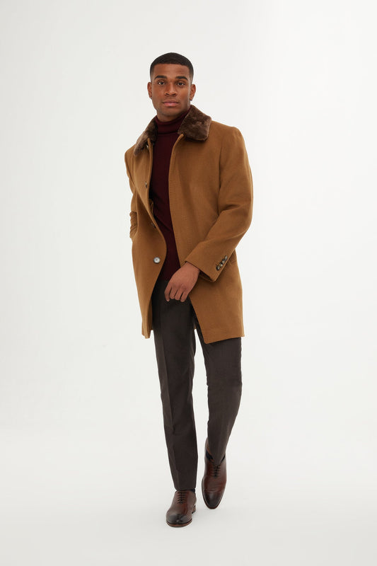 A tan wool overcoat with a plush brown fur collar.