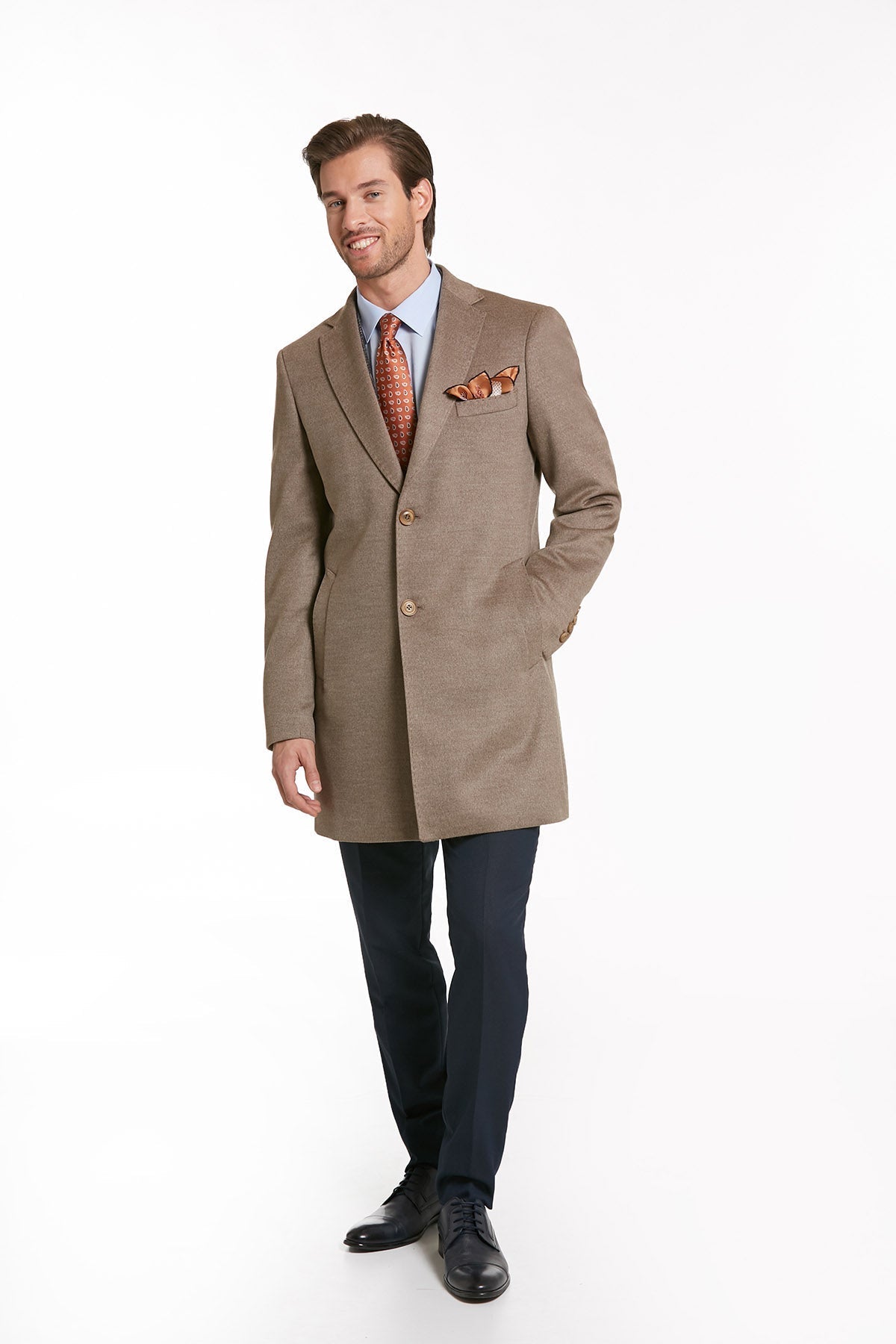 A tailored beige overcoat with a subtle textured weave, featuring two front buttons and a matching pocket square.