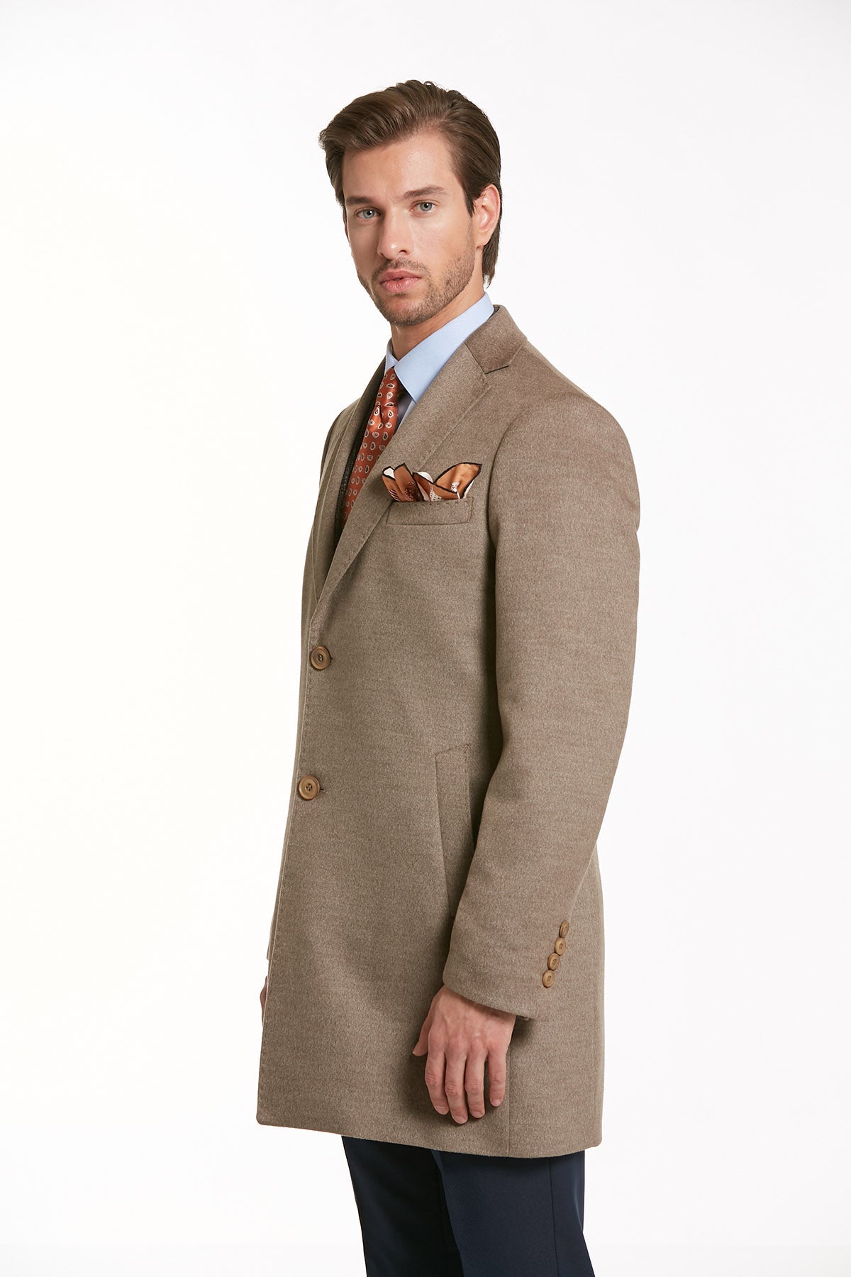A tailored beige wool overcoat with a subtle textured pattern and matching brown buttons.
