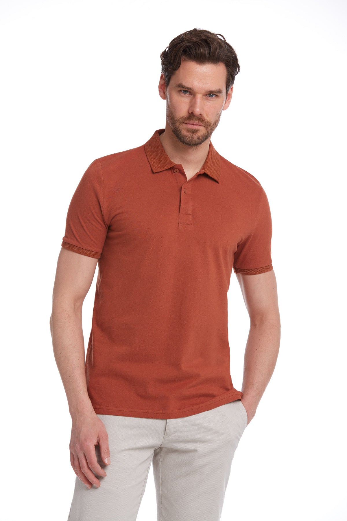 A men’s rust-colored short-sleeved polo shirt with a classic collar and buttoned placket.
