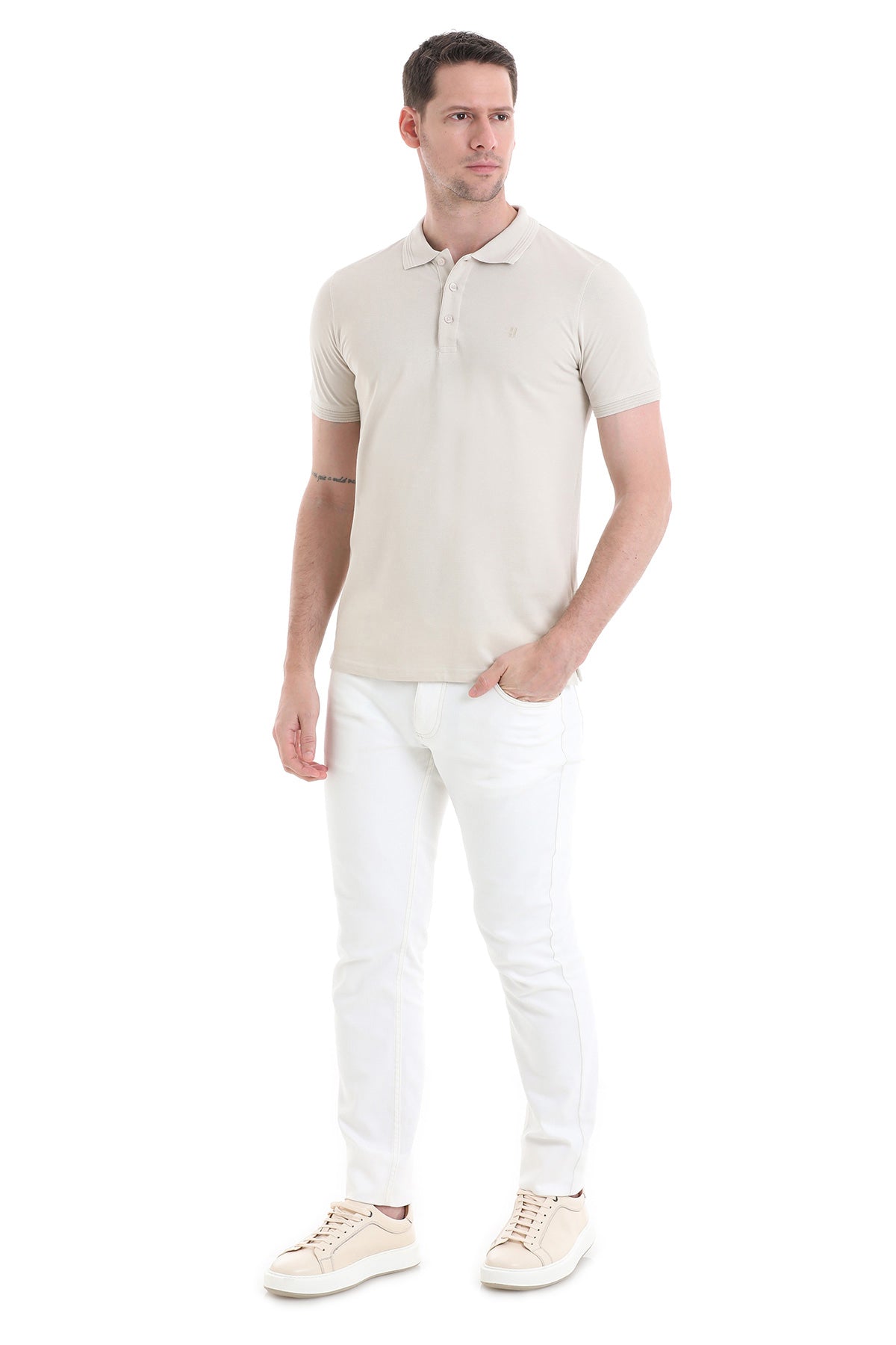A man wearing a beige short-sleeved polo shirt with a classic collar and button placket.