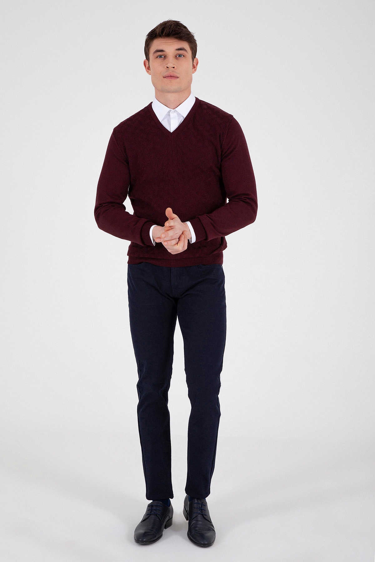 Maroon v-neck sweater with ribbed cuffs and hem.