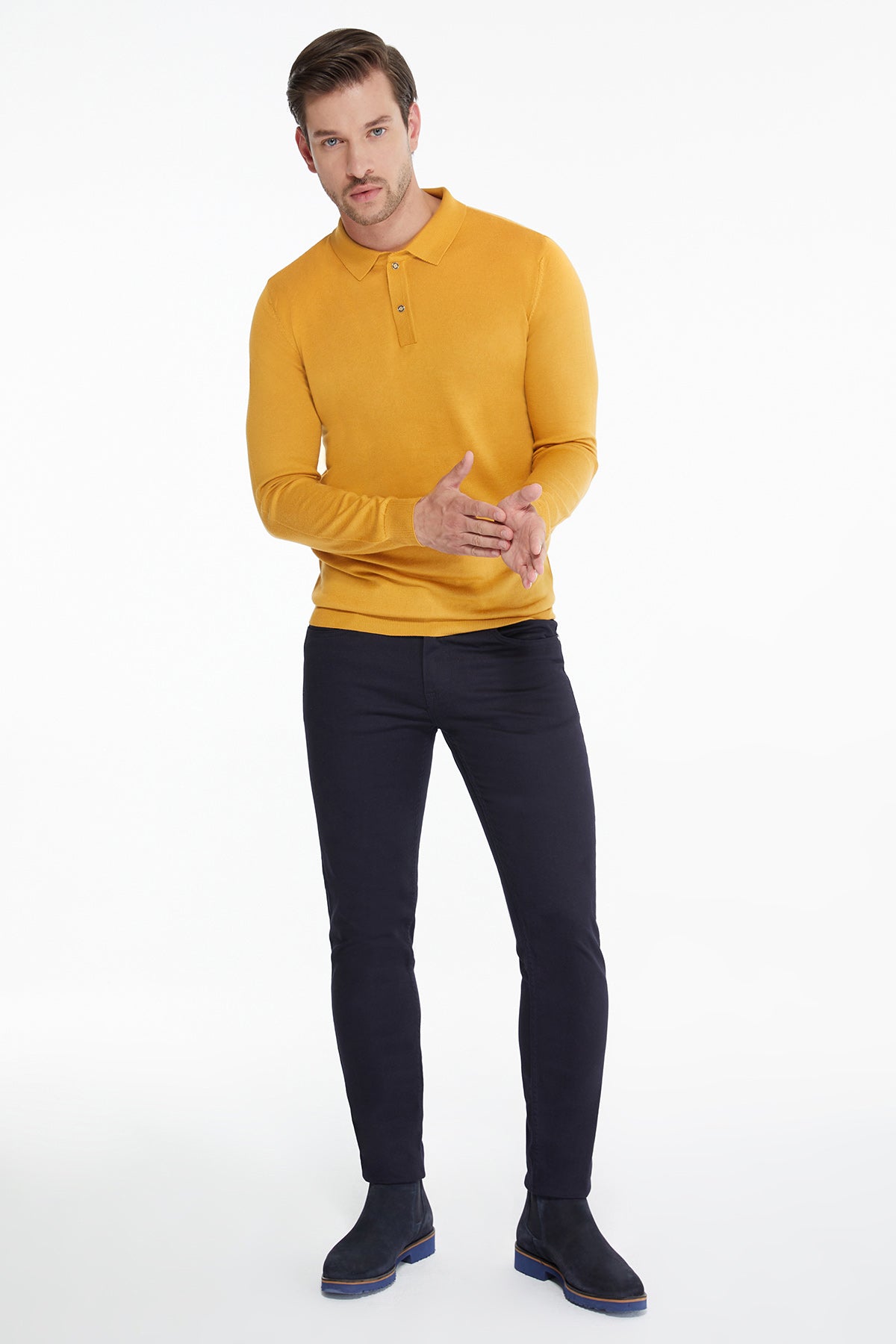 A man wearing a vibrant yellow long-sleeved polo shirt with a classic collar and buttoned placket.