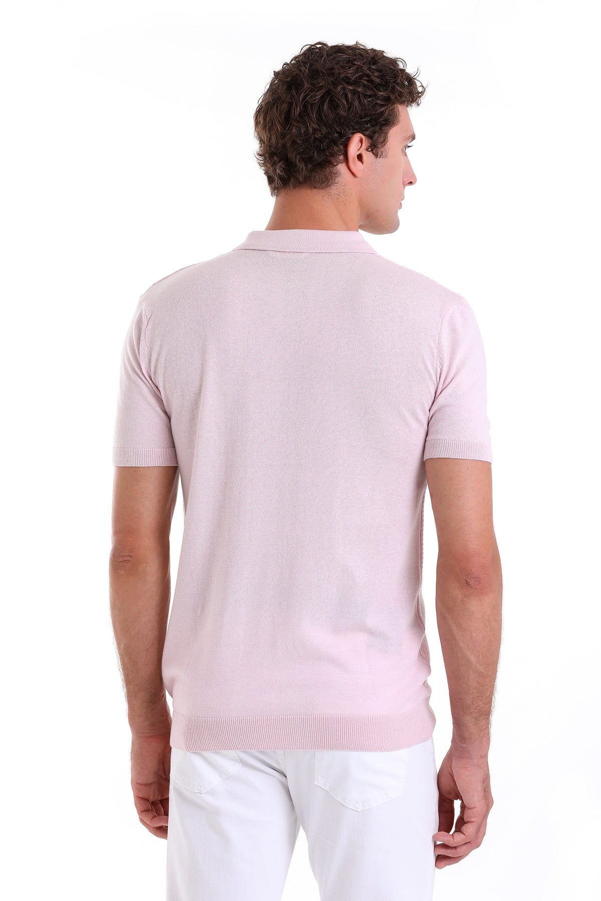 A soft pink short-sleeved knit polo shirt with a ribbed collar and hem.
