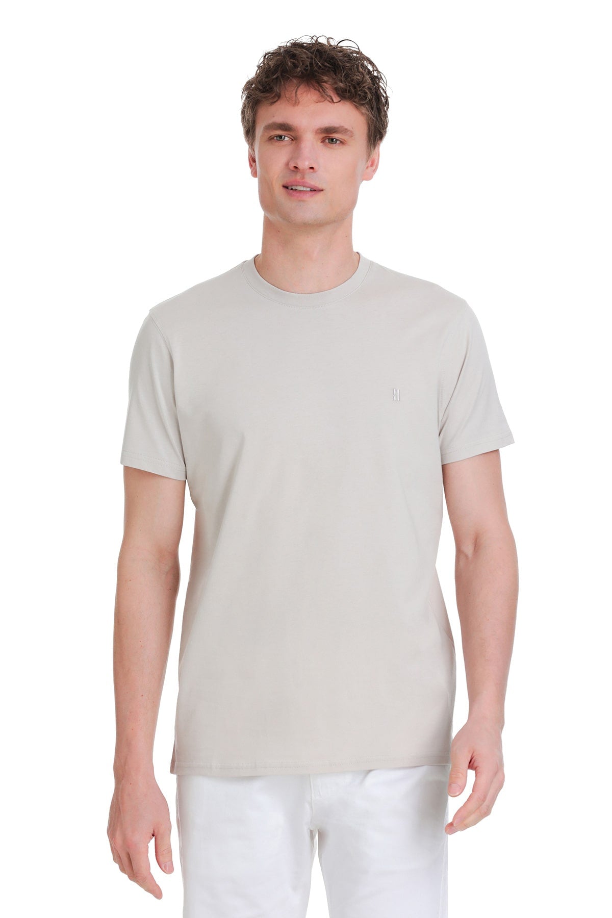 A minimalist off-white crew-neck t-shirt with a subtle embroidered logo on the left chest.