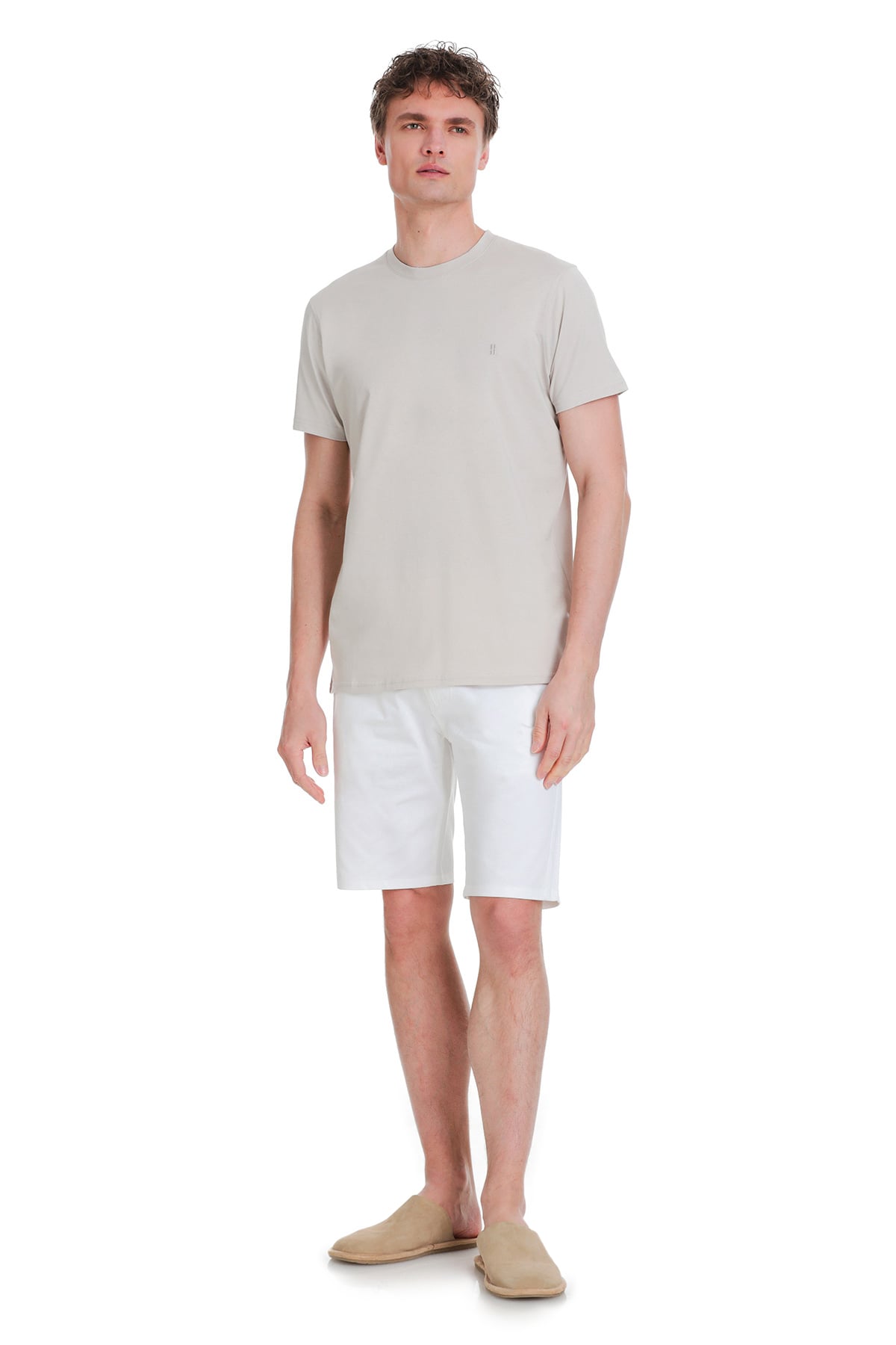 A light beige, short-sleeved crew neck t-shirt with a subtle embroidered logo on the left chest.