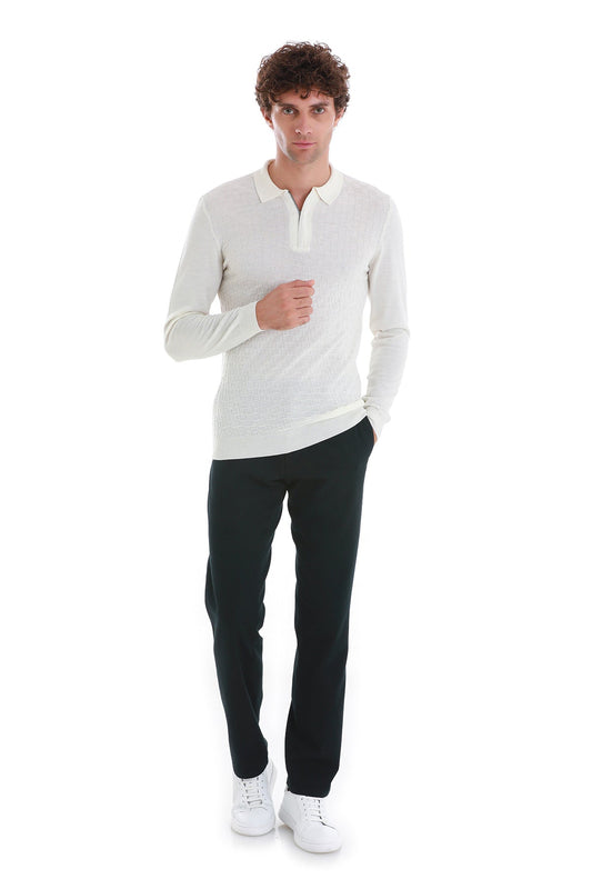 A man wearing a white long-sleeved polo shirt with a subtle textured knit pattern.