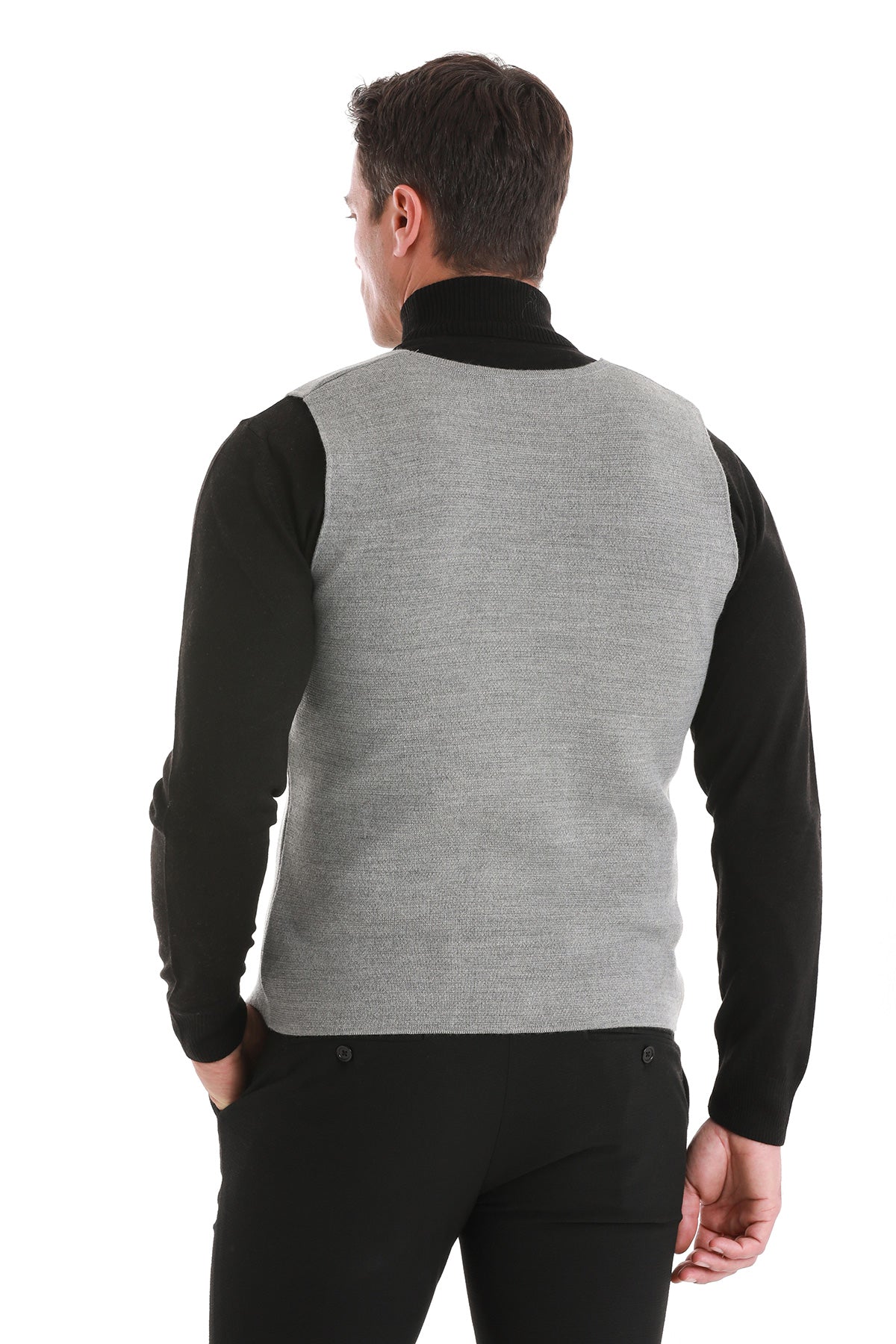 Gray textured knit vest with black long sleeves and a high collar.