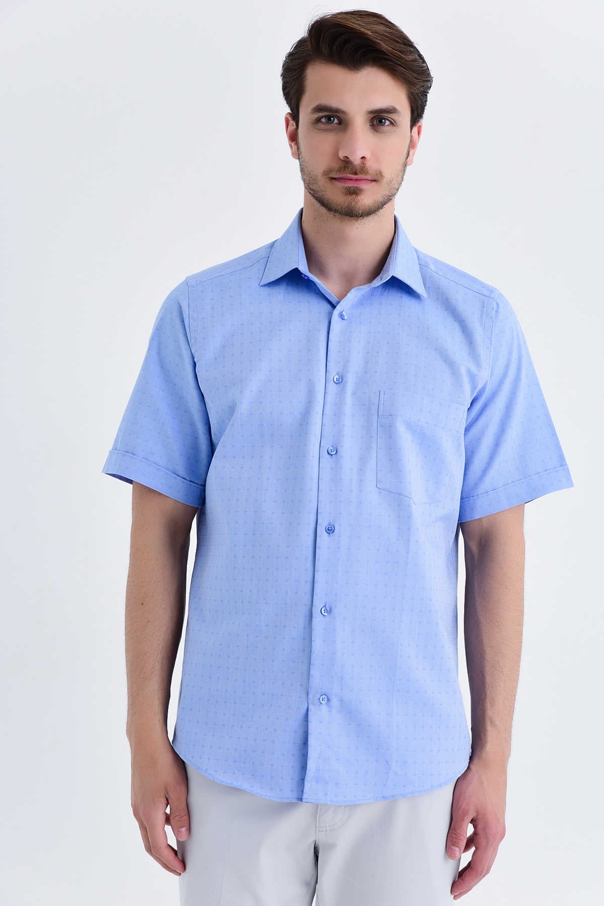 Light blue short-sleeved button-down shirt with a subtle textured weave and a single chest pocket.