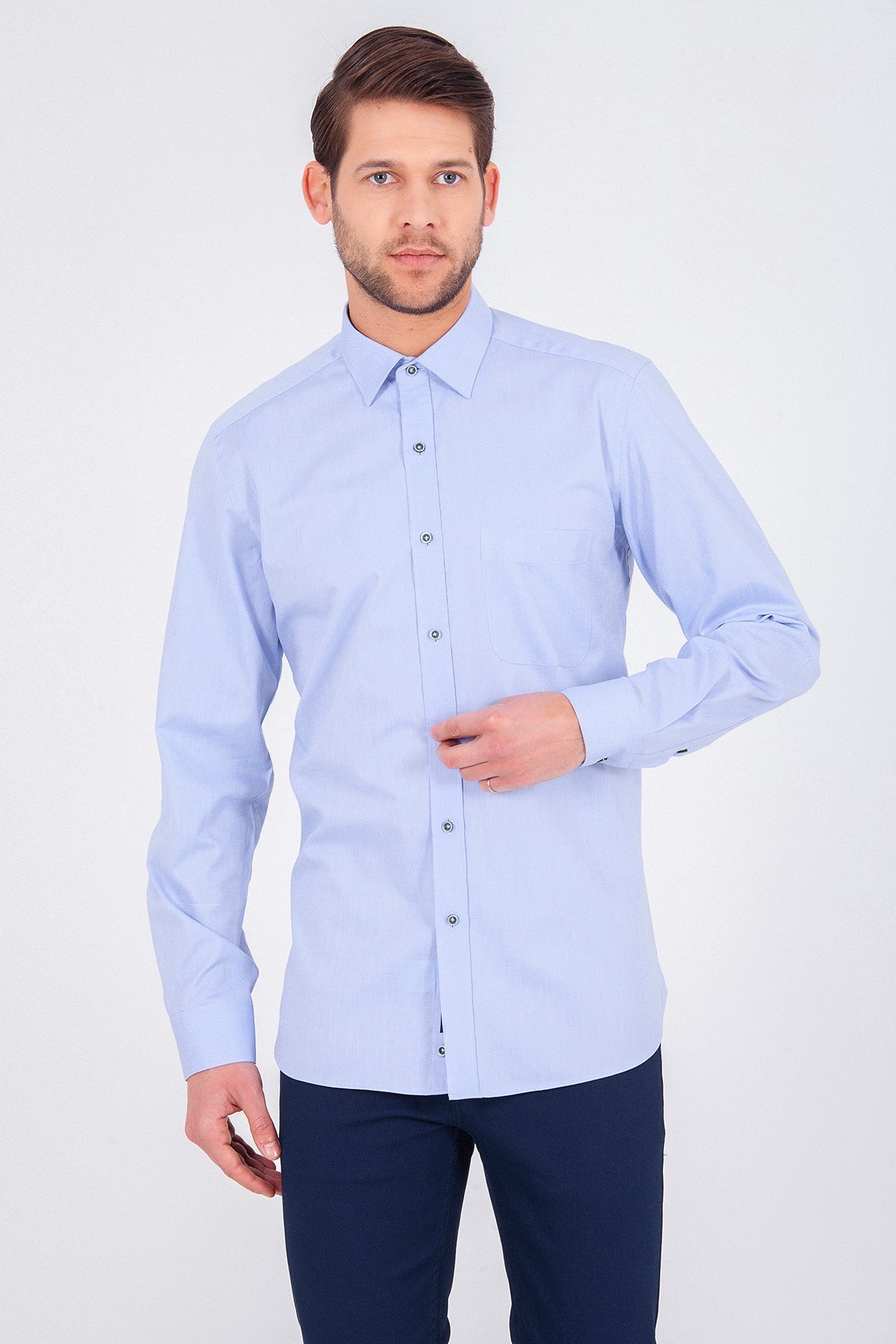 A light blue, long-sleeved men’s dress shirt with a classic collar and button-down front.