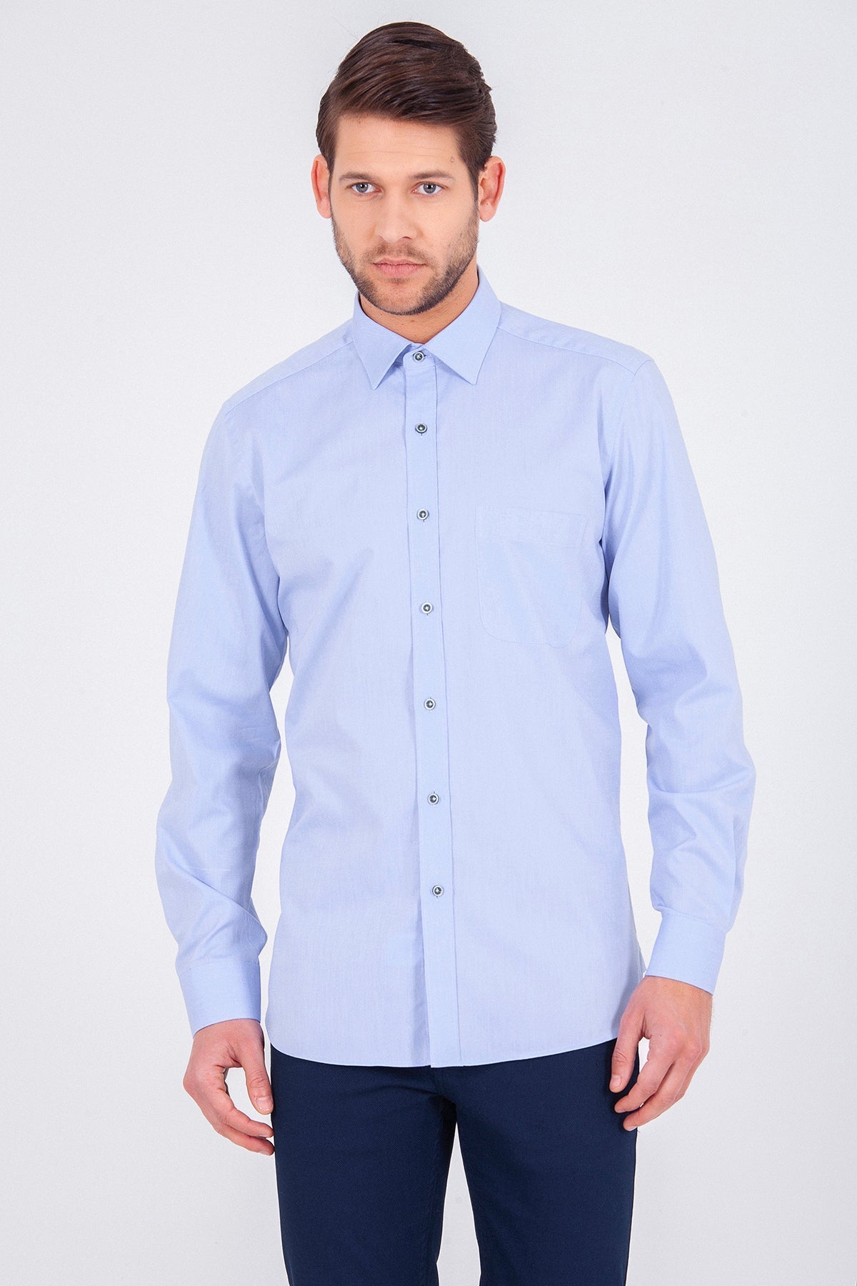 A light blue, long-sleeved men’s dress shirt with a classic collar and button-down front.