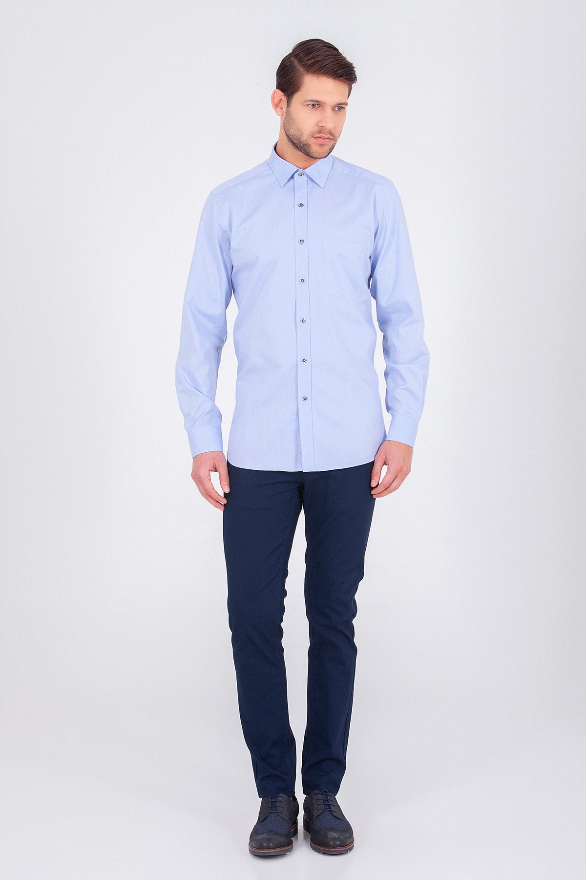 A light blue, long-sleeved men’s dress shirt with a classic collar and button-down front.
