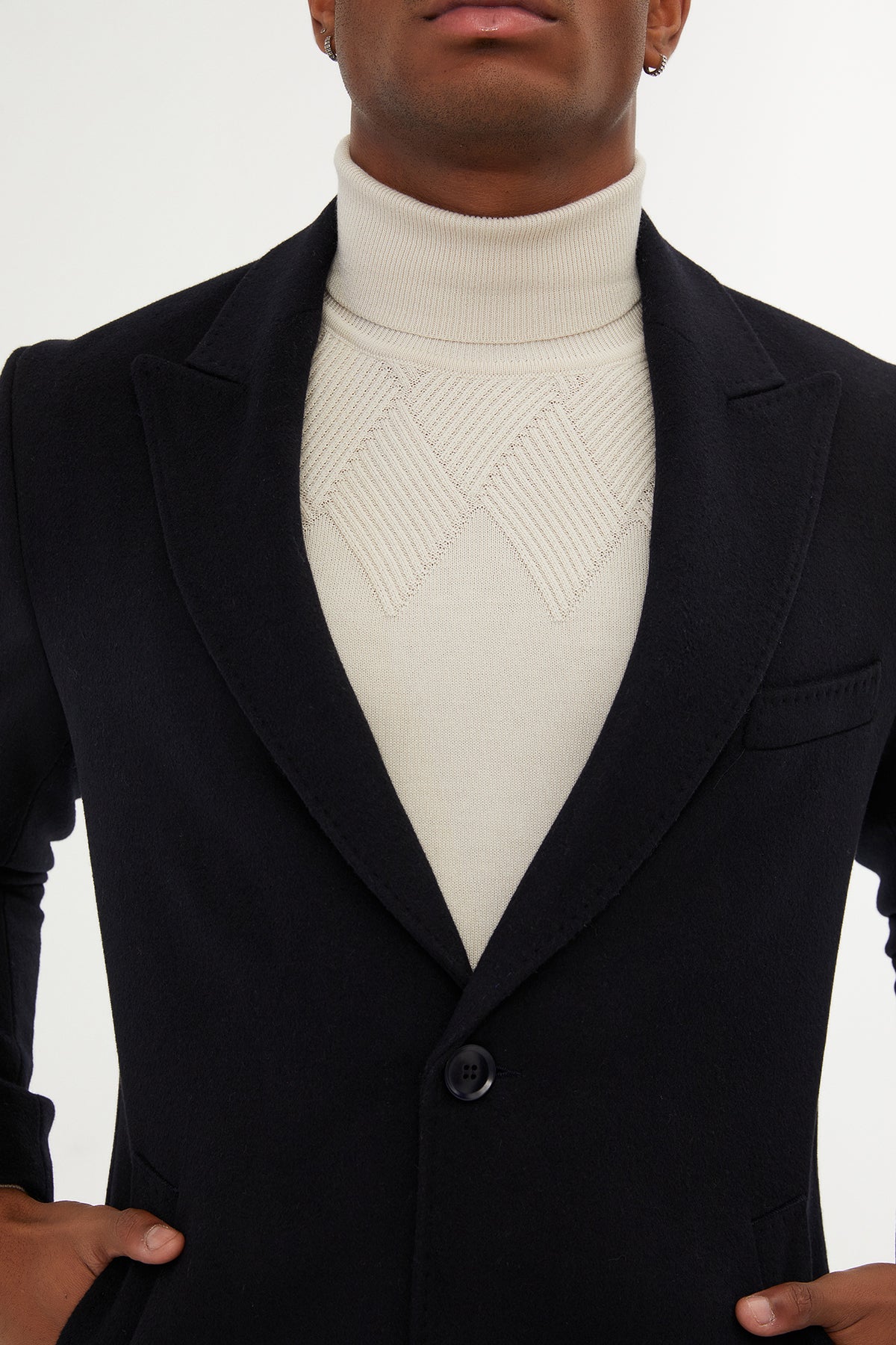 Black blazer with a single button and notched lapels.
