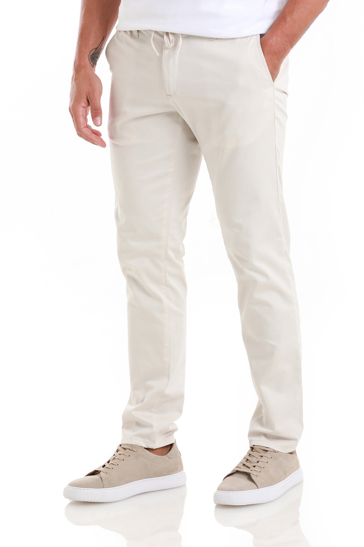 Beige chino pants with a drawstring waistband and tapered legs.