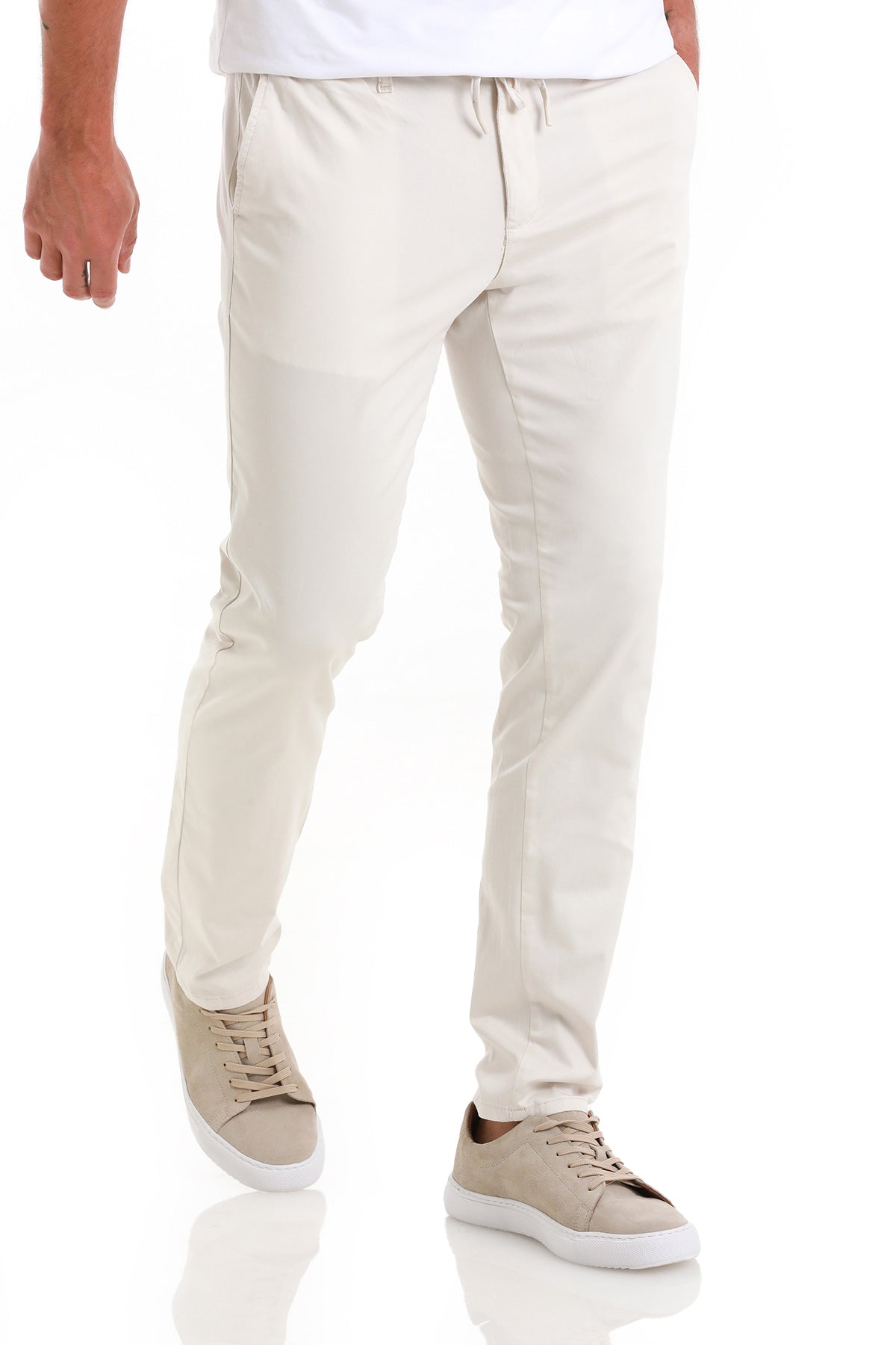 Cream-colored, slim-fit chino pants with a drawstring waistband.