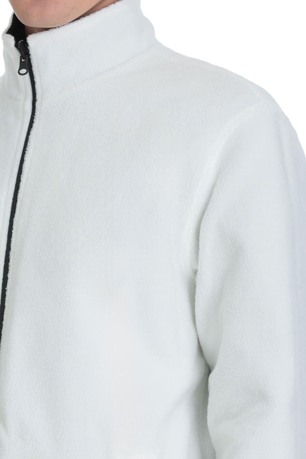 White fleece zip-up jacket with a black zipper and ribbed collar.