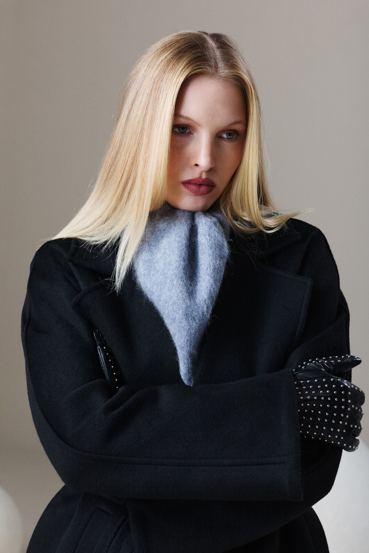 Sayki woman dynamic fit black oversized short coat with a light blue fluffy scarf draped around the neck