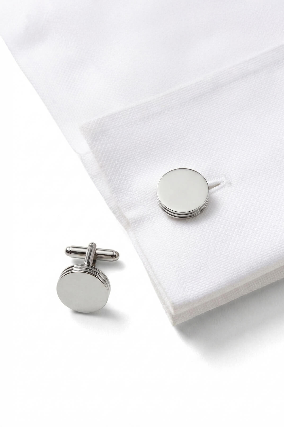 Silver toned natural stone round cufflinks with polished metallic finish and subtle concentric ring detailing