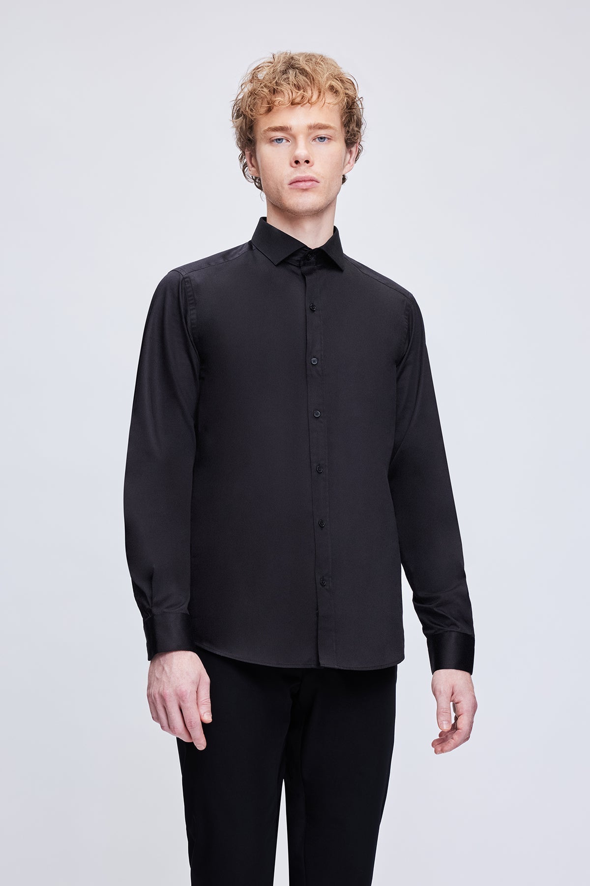 Black long-sleeved button-up shirt with a crisp collar and subtle sheen.