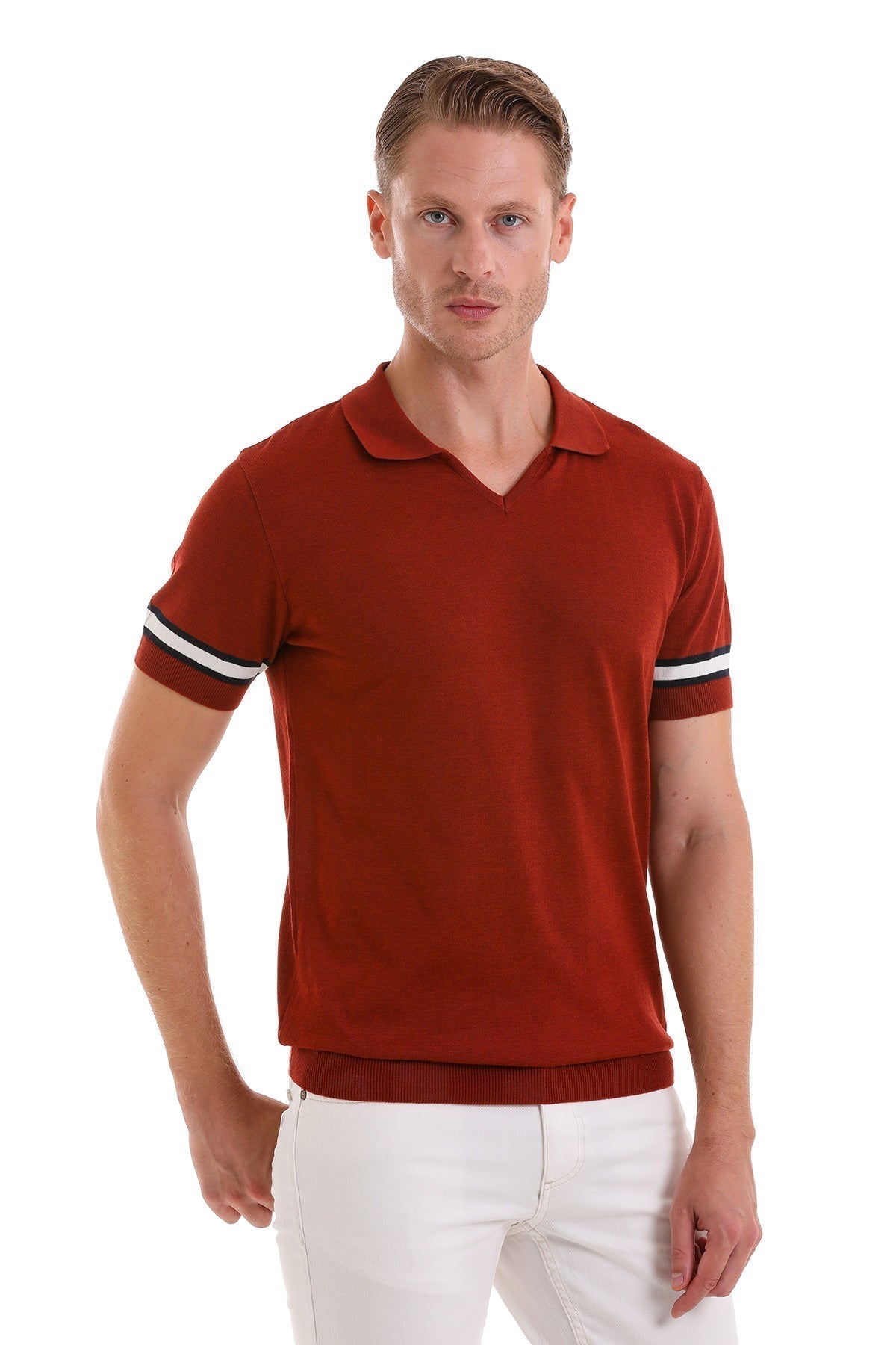 A men’s rust-colored knit polo shirt with white and black striped cuffs.