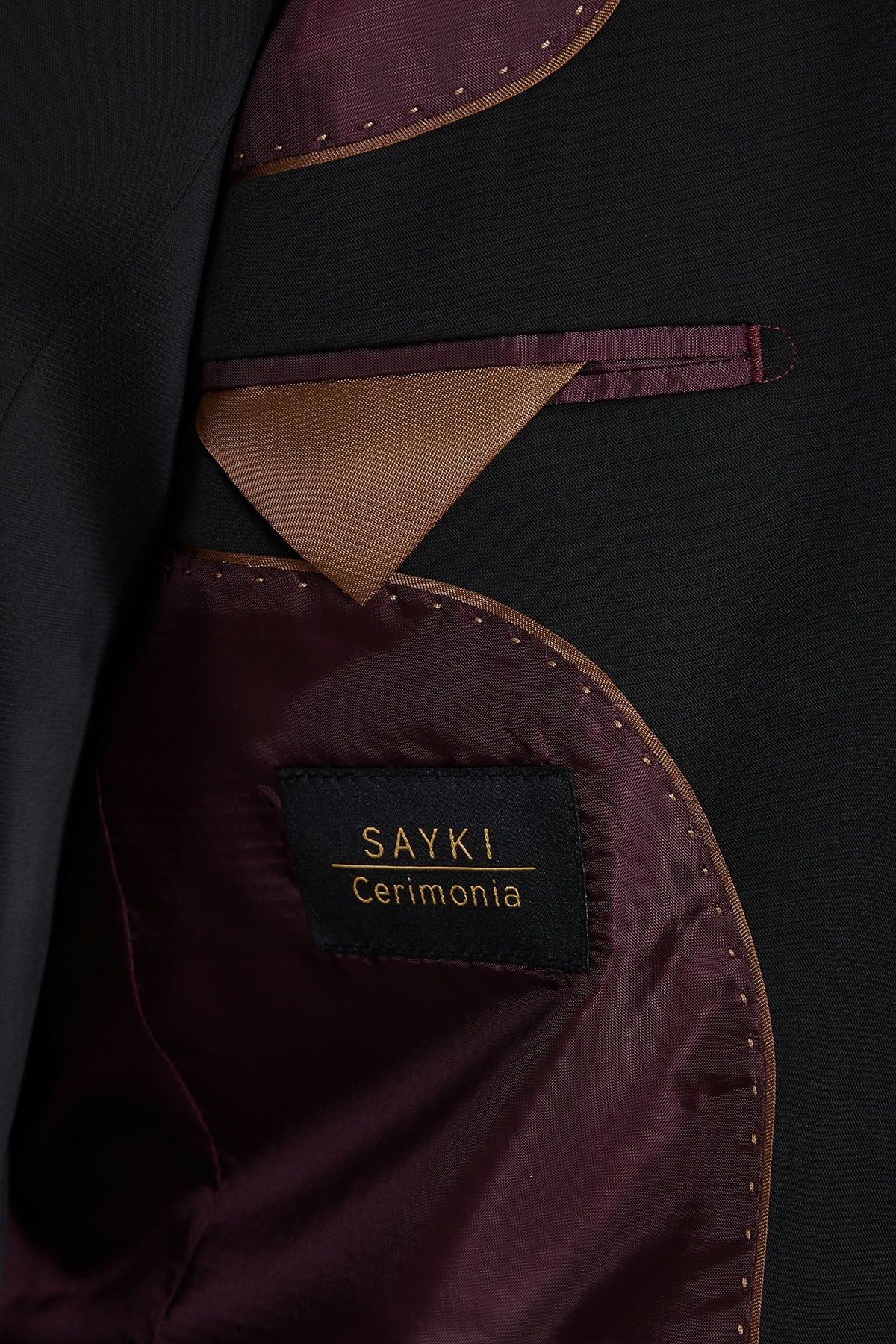 Black satin interior lining with gold-stitched edges and a contrasting maroon fabric pocket square.
