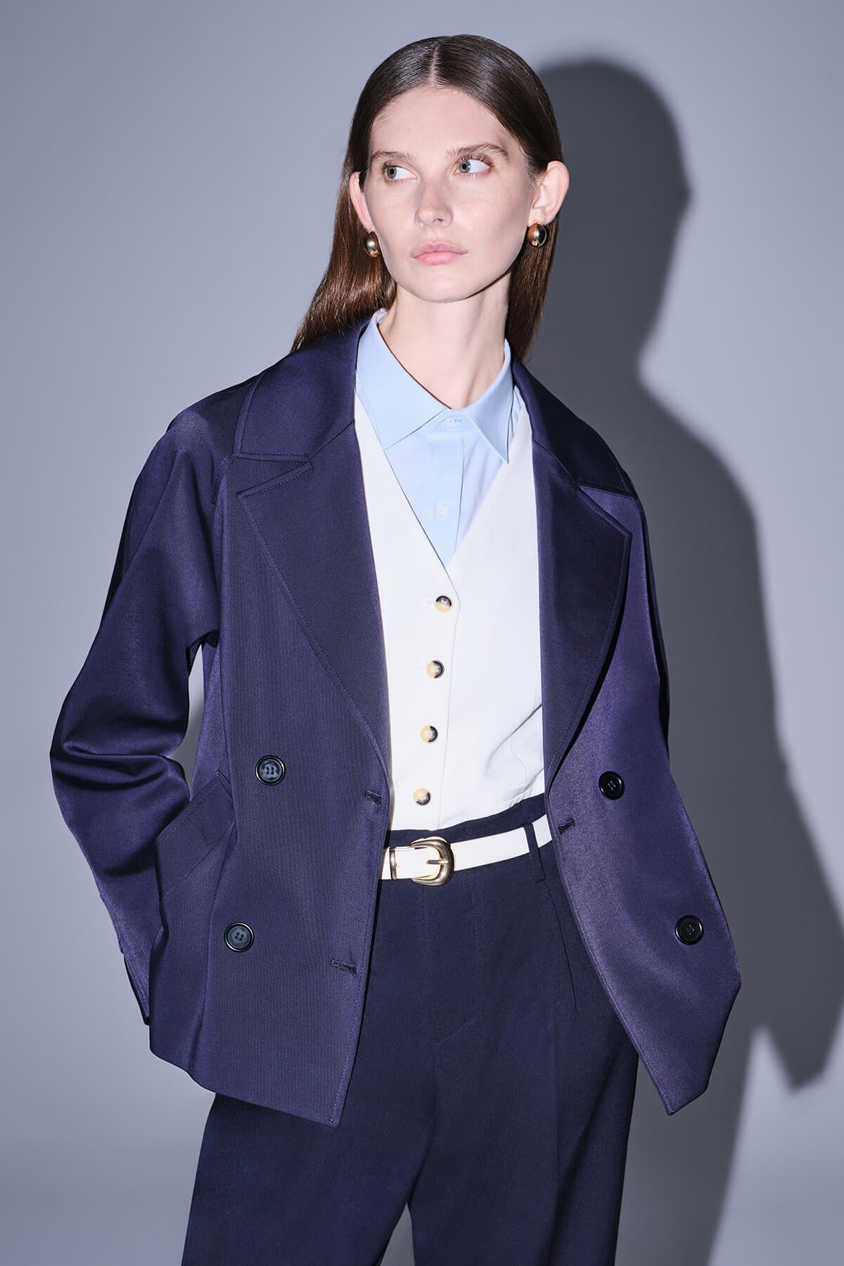 Navy blue satin blazer with subtle vertical ribbing and black buttons