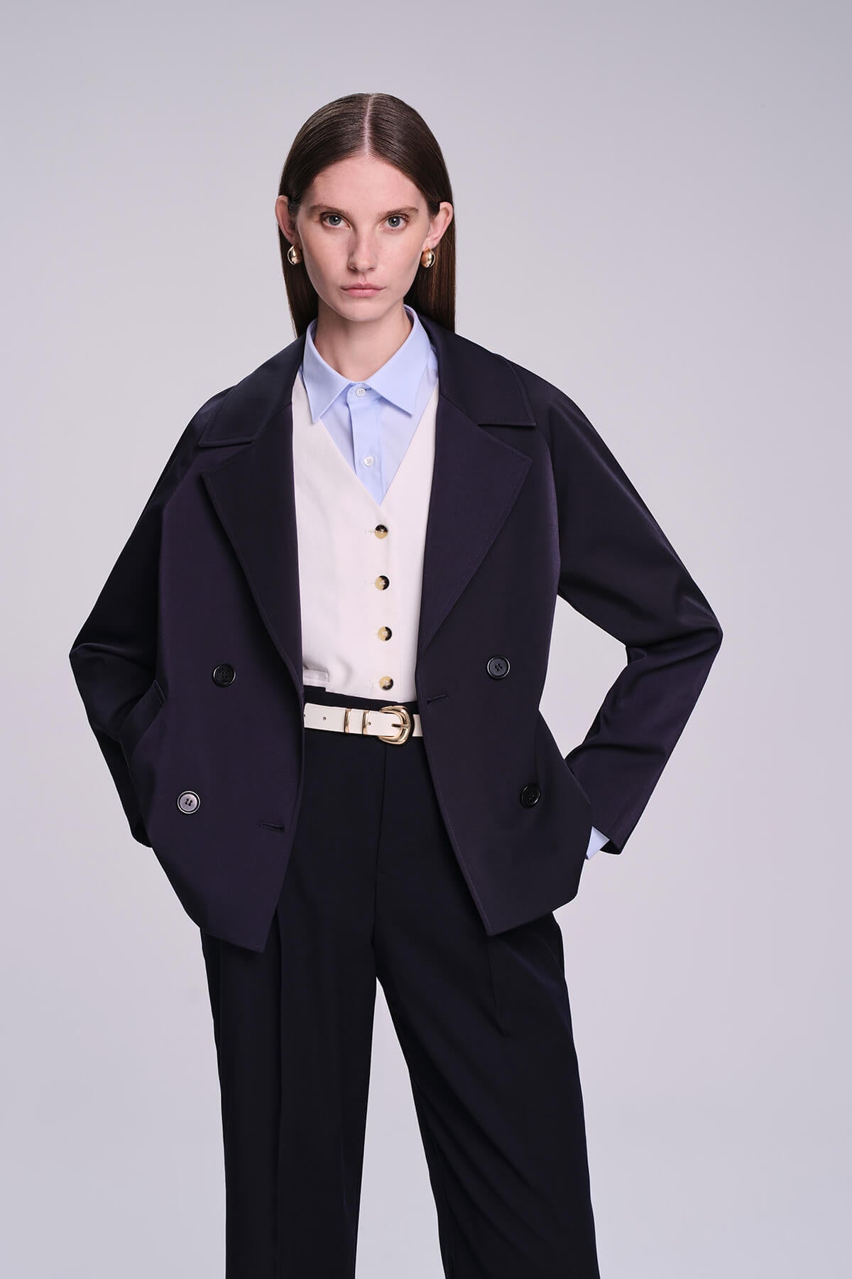 Navy blue double-breasted blazer with structured shoulders and gold-tone buttons