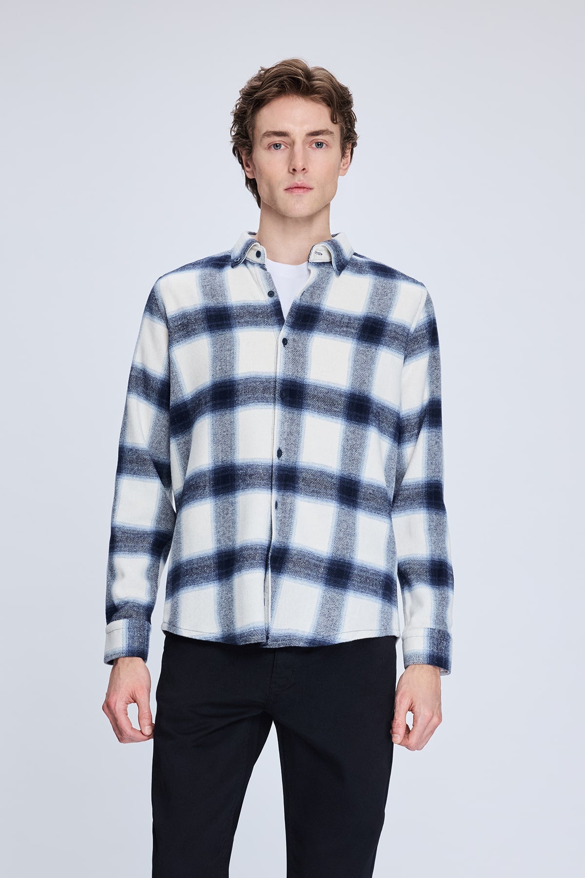 A navy and white plaid flannel shirt with a soft, textured fabric.
