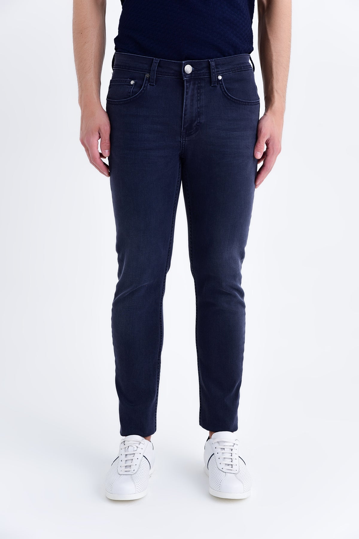 Dark blue slim-fit denim jeans with a classic five-pocket design and white button closure.