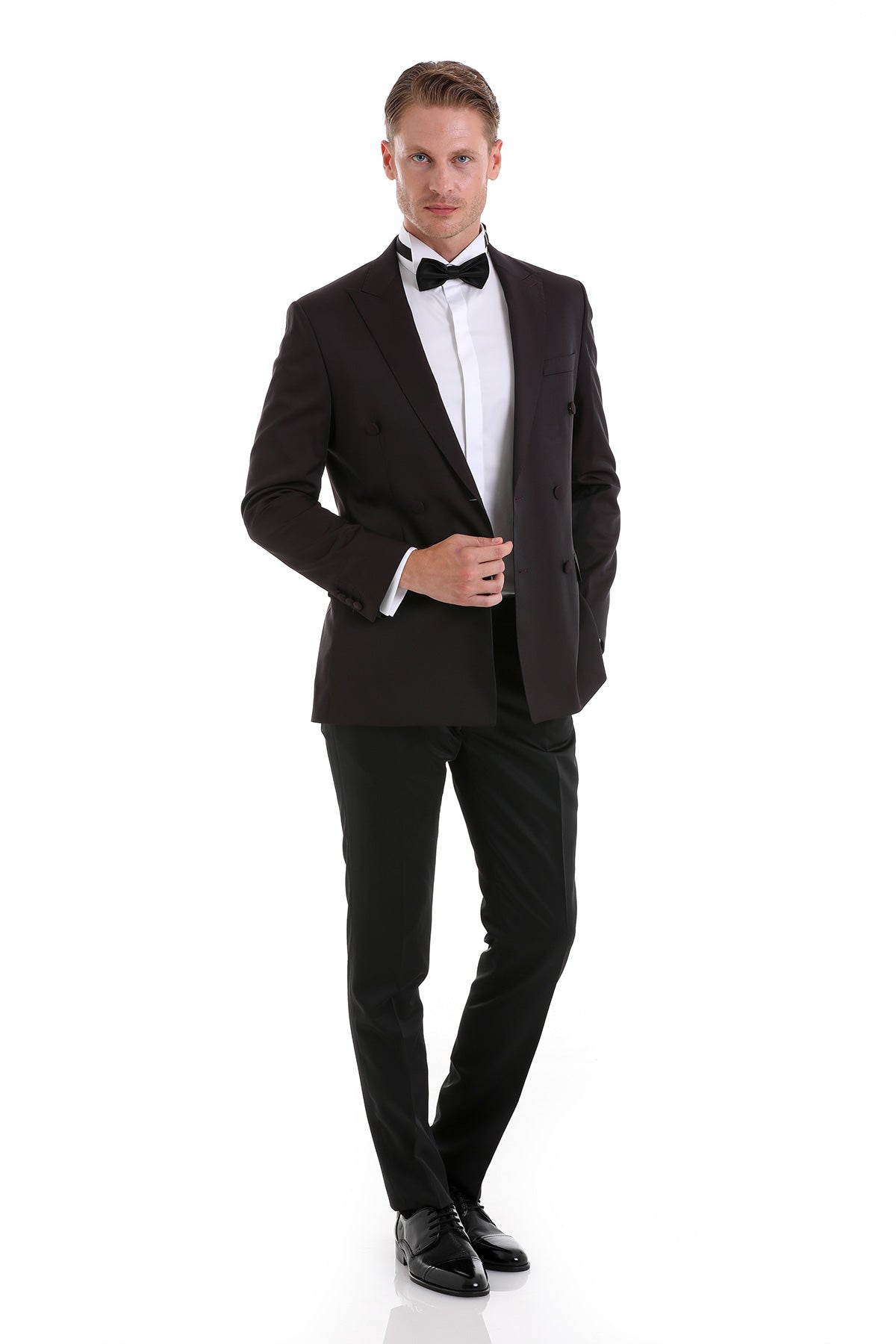 Black tuxedo jacket with notched lapels and double-breasted front, paired with matching trousers.
