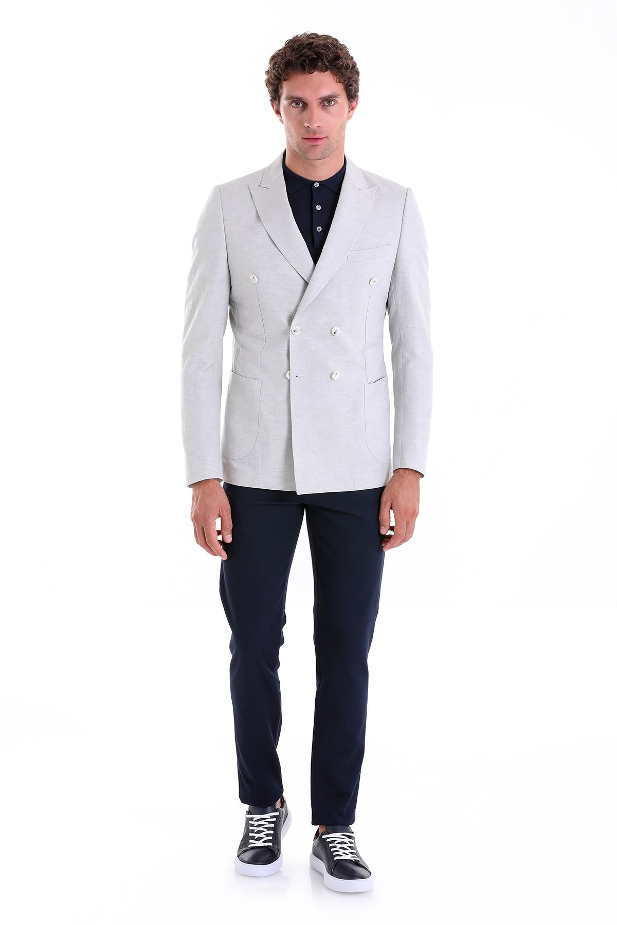 A sleek, light gray double-breasted suit jacket with a tailored fit and contrasting dark navy trousers.