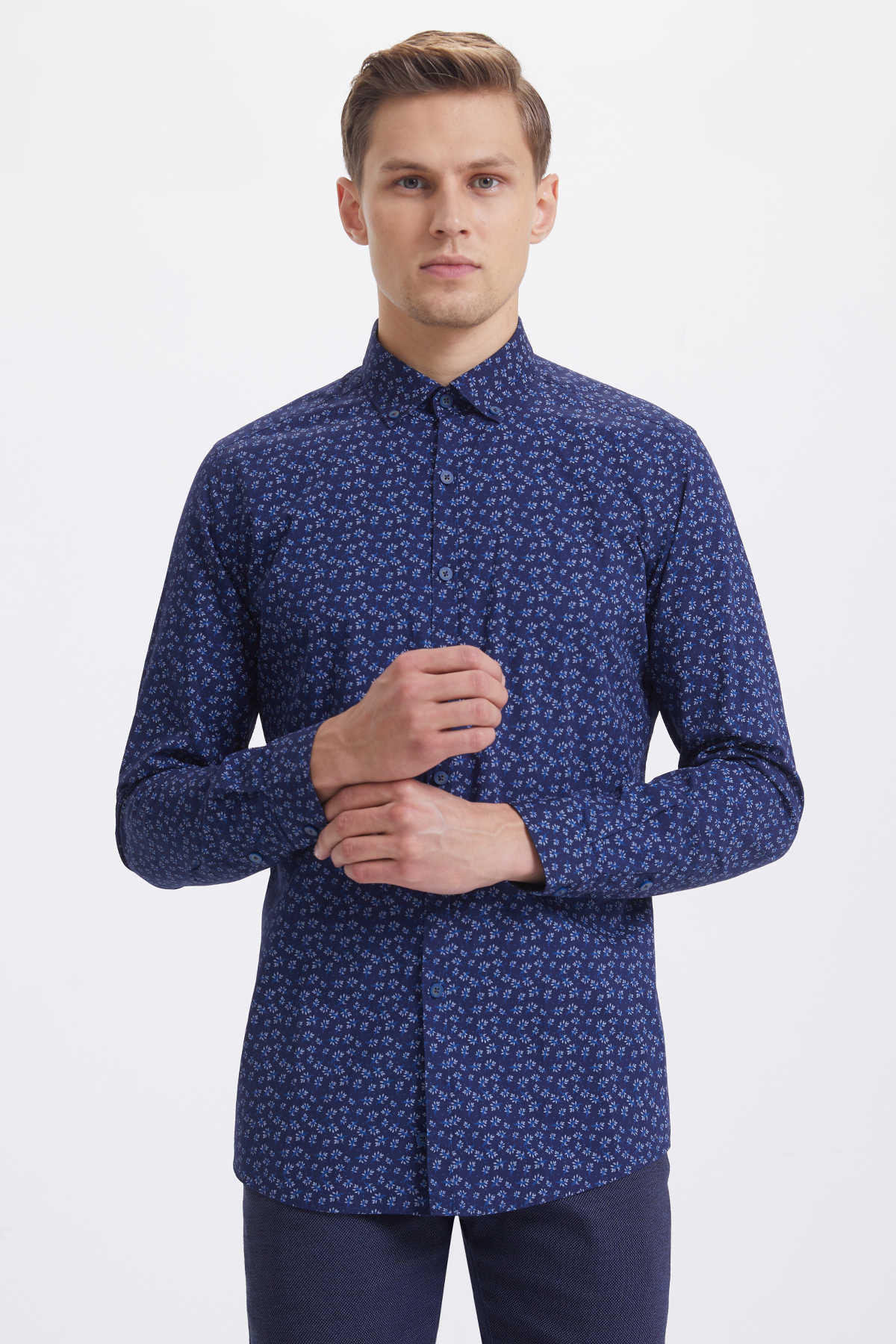 A navy blue long-sleeved button-down shirt with a subtle white floral pattern.