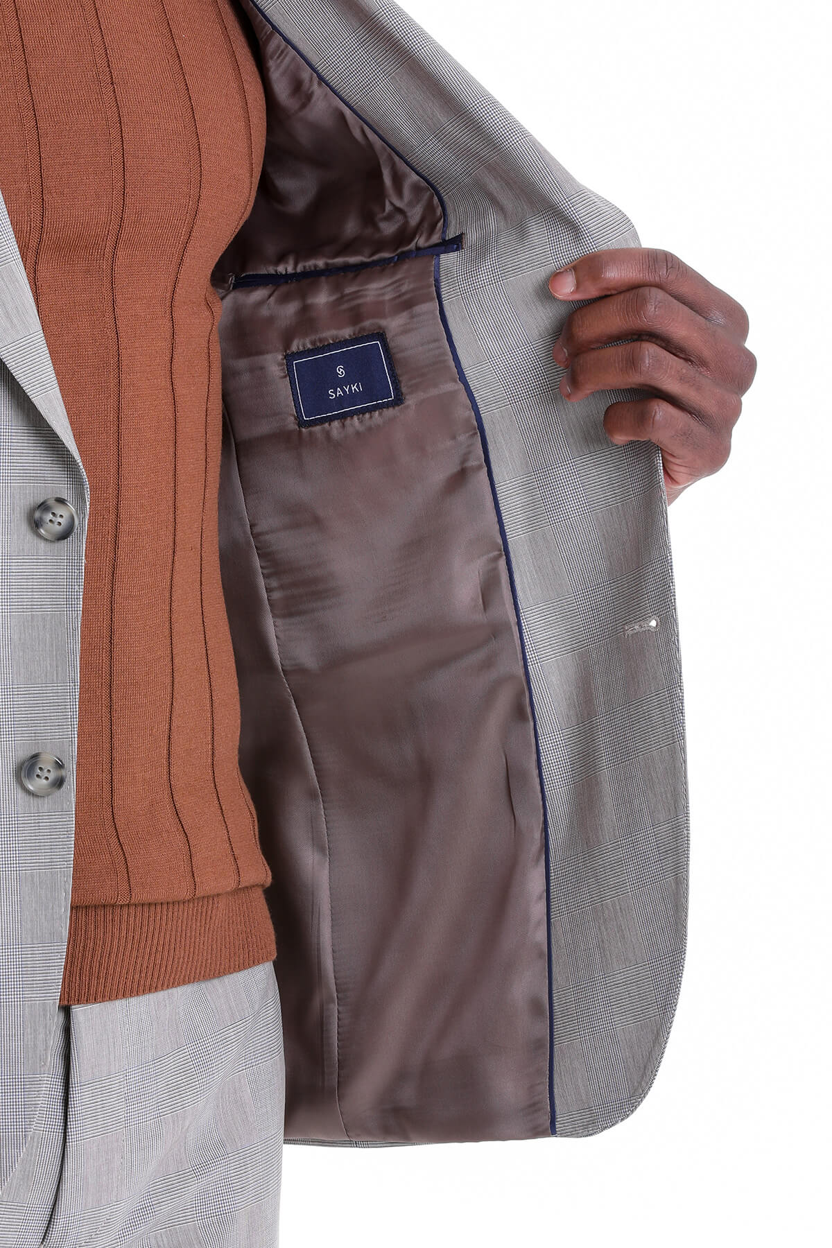 Gray plaid blazer with a brown satin lining and navy trim.
