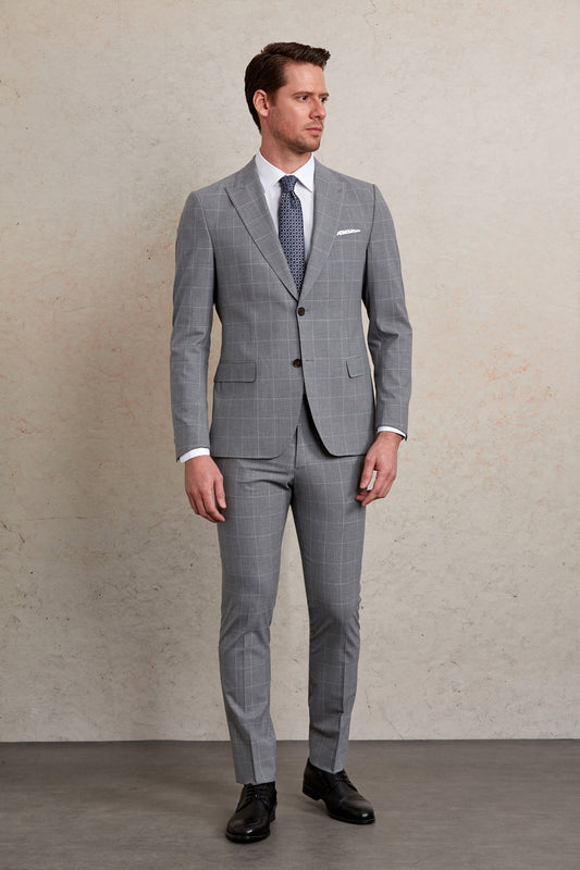 A tailored gray suit with a subtle checkered pattern, featuring classic double-breasted styling and matching trousers.