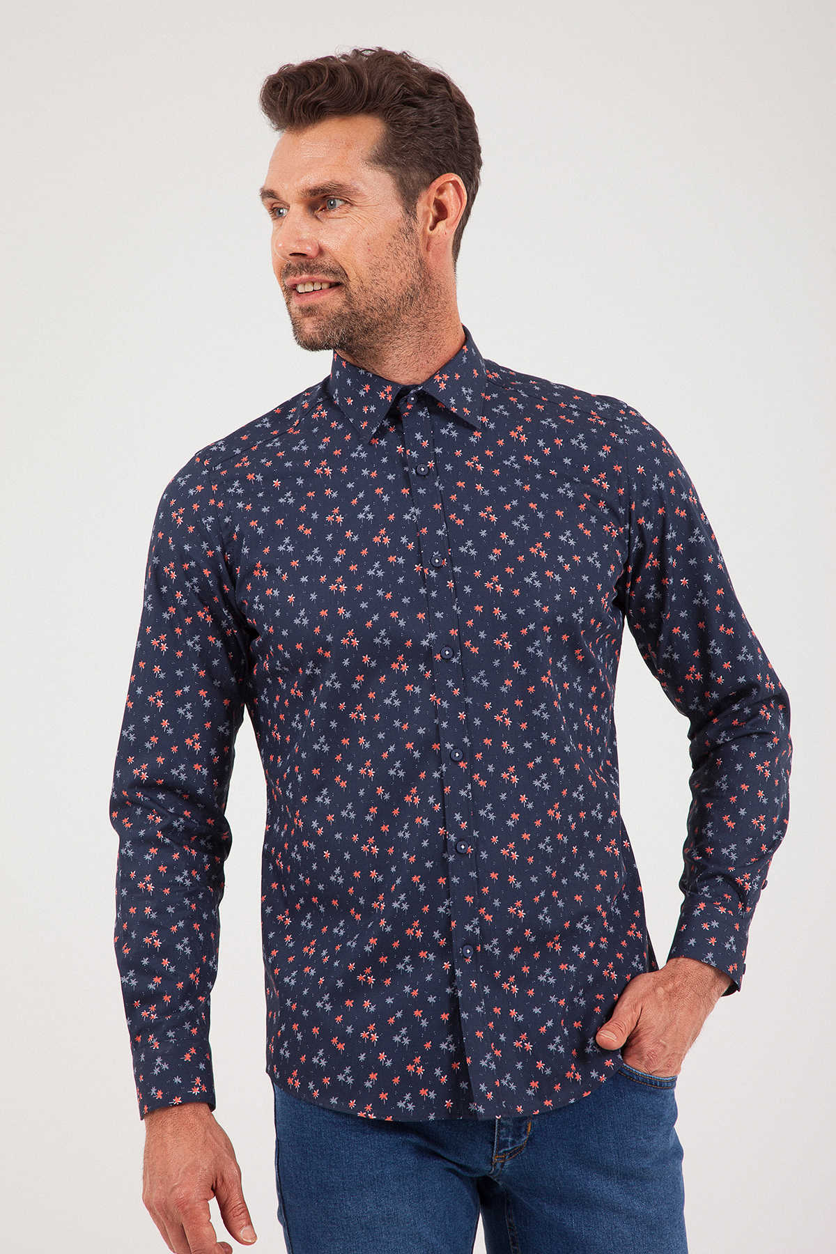 A navy blue long-sleeved button-up shirt with a subtle pattern of small pink and light blue floral motifs.