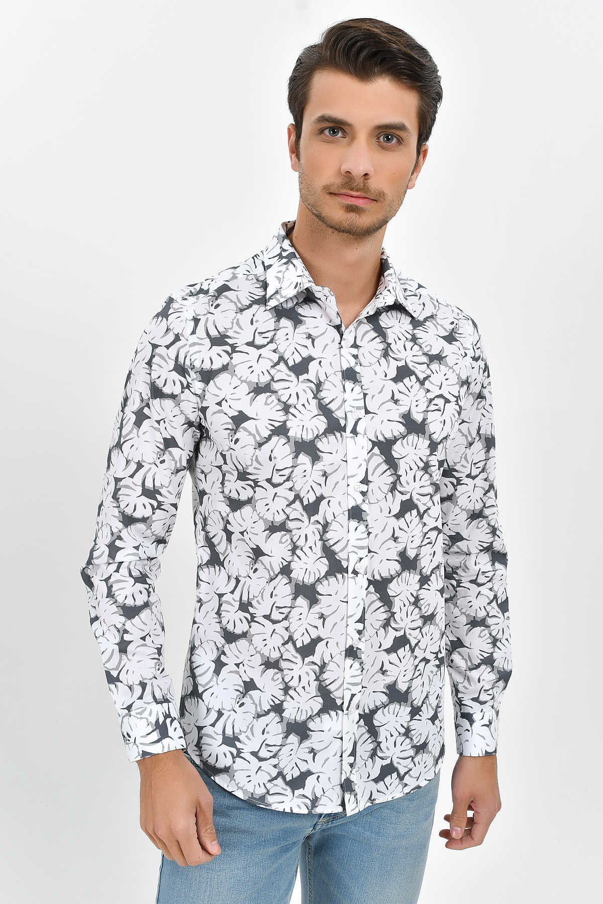 White and black monstera leaf patterned long-sleeve button-up shirt.