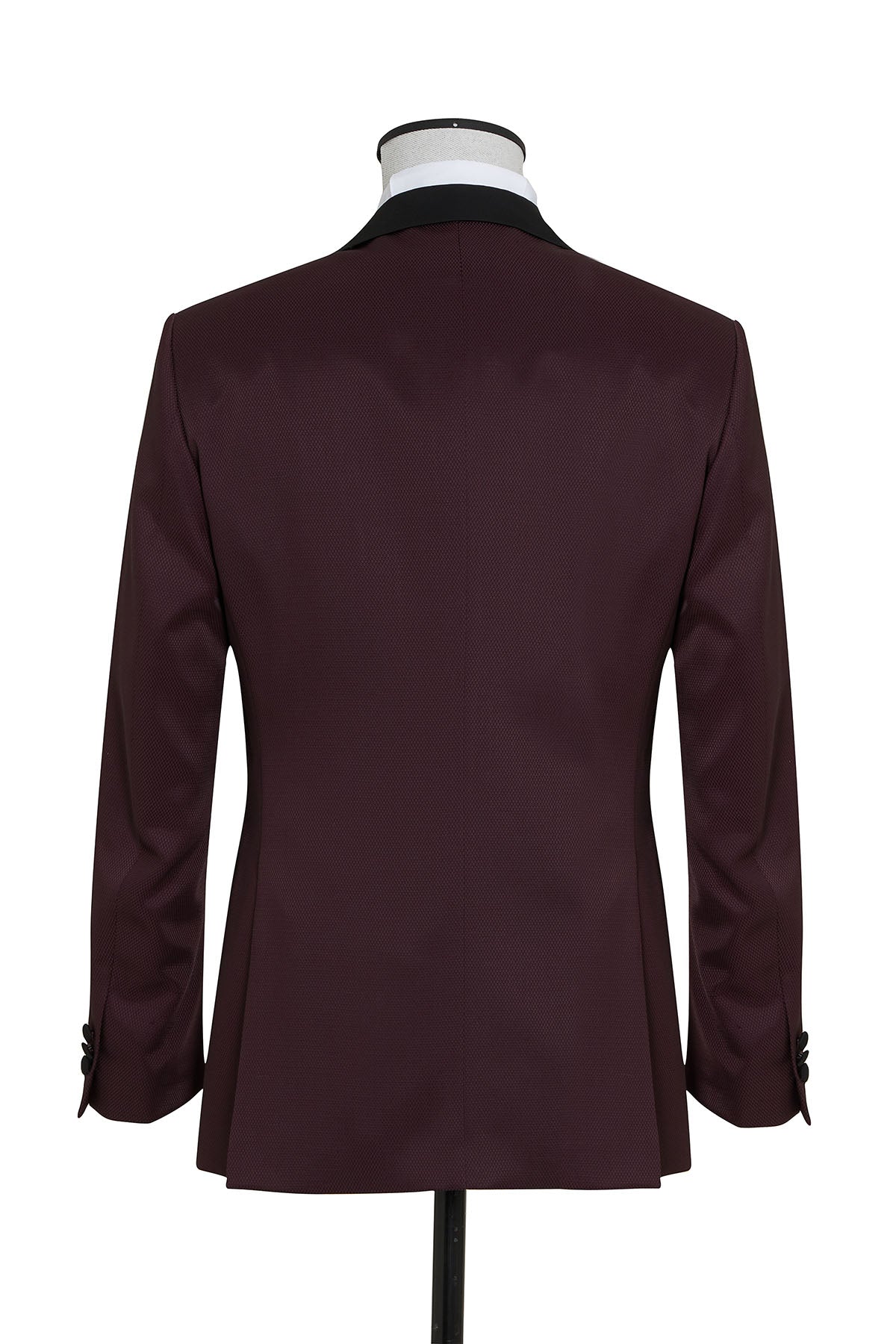 A sleek, burgundy suit jacket with a black satin lapel and matching buttoned cuffs.