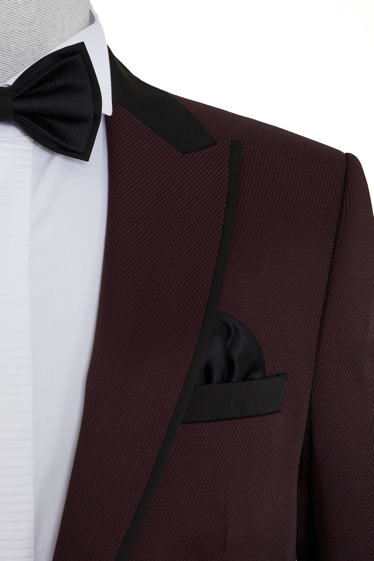 A maroon tuxedo jacket with black satin lapels and trim, featuring a matching pocket square.