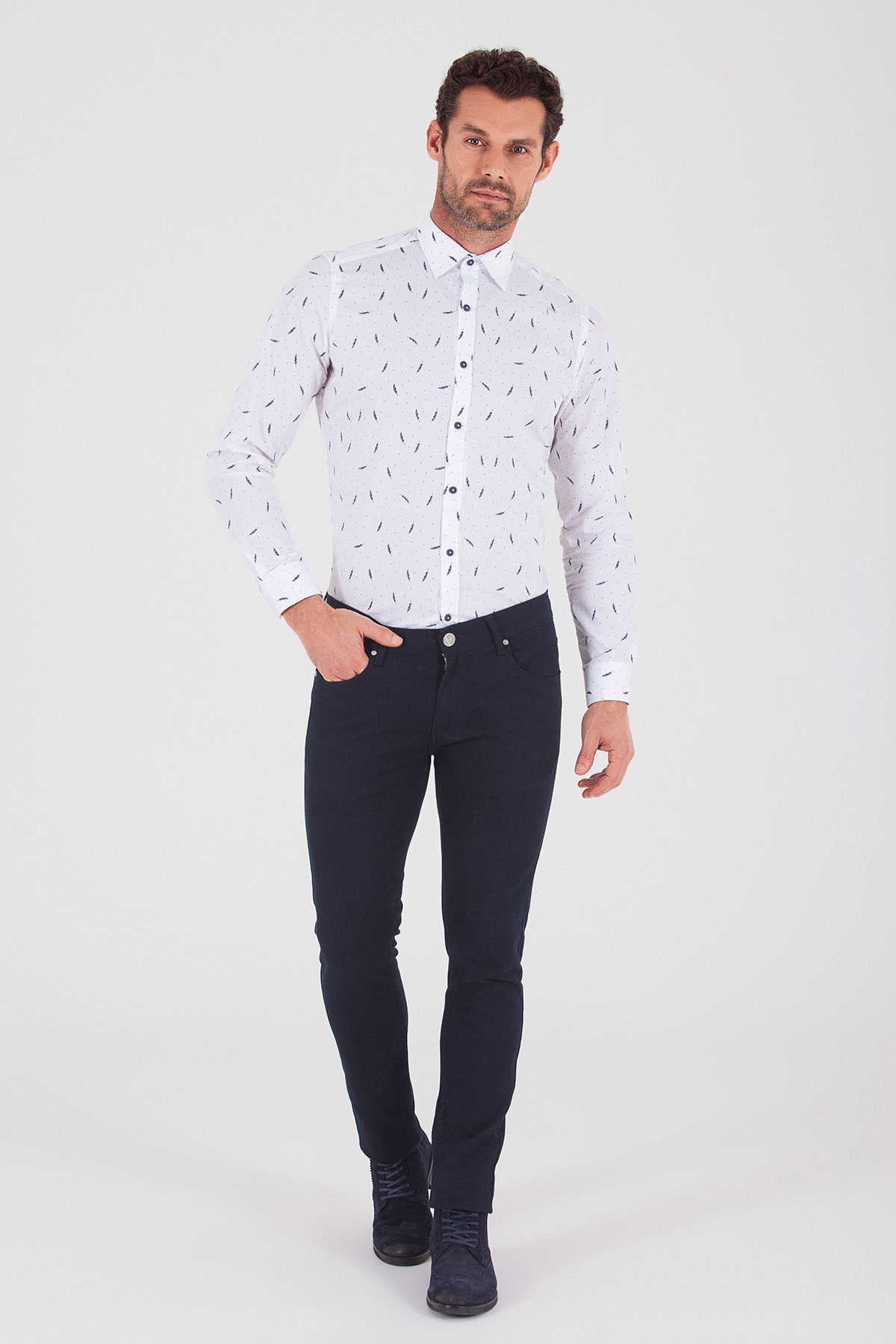 White long-sleeved button-up shirt with a subtle black geometric pattern.