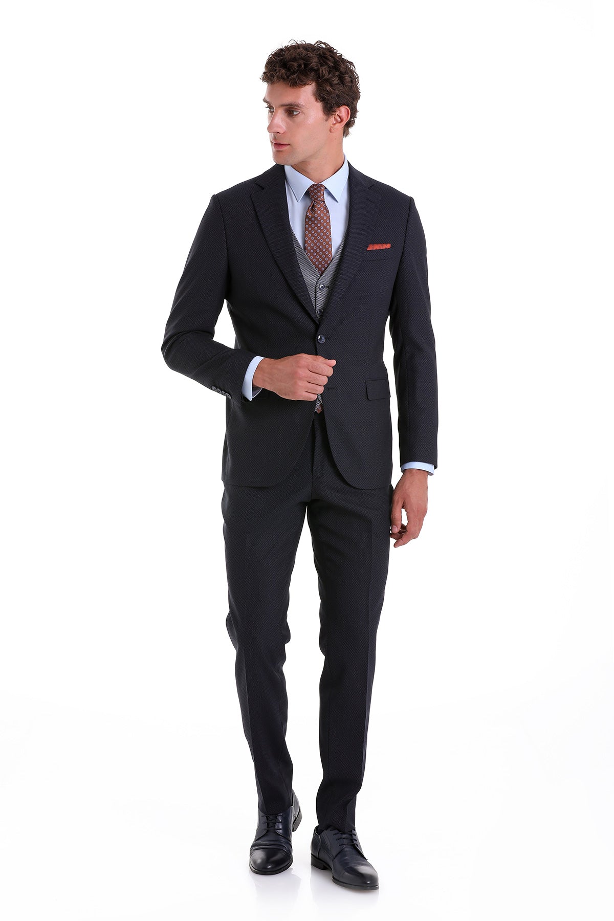 A sharply tailored black suit with a subtle texture, featuring a matching vest and trousers.