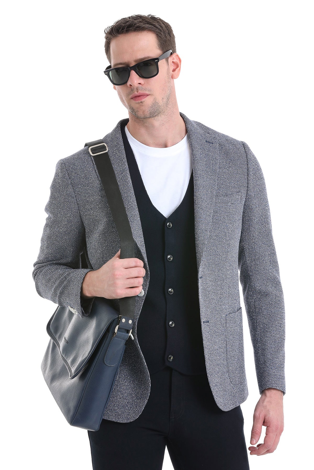 Gray textured blazer with black vest and white t-shirt underneath